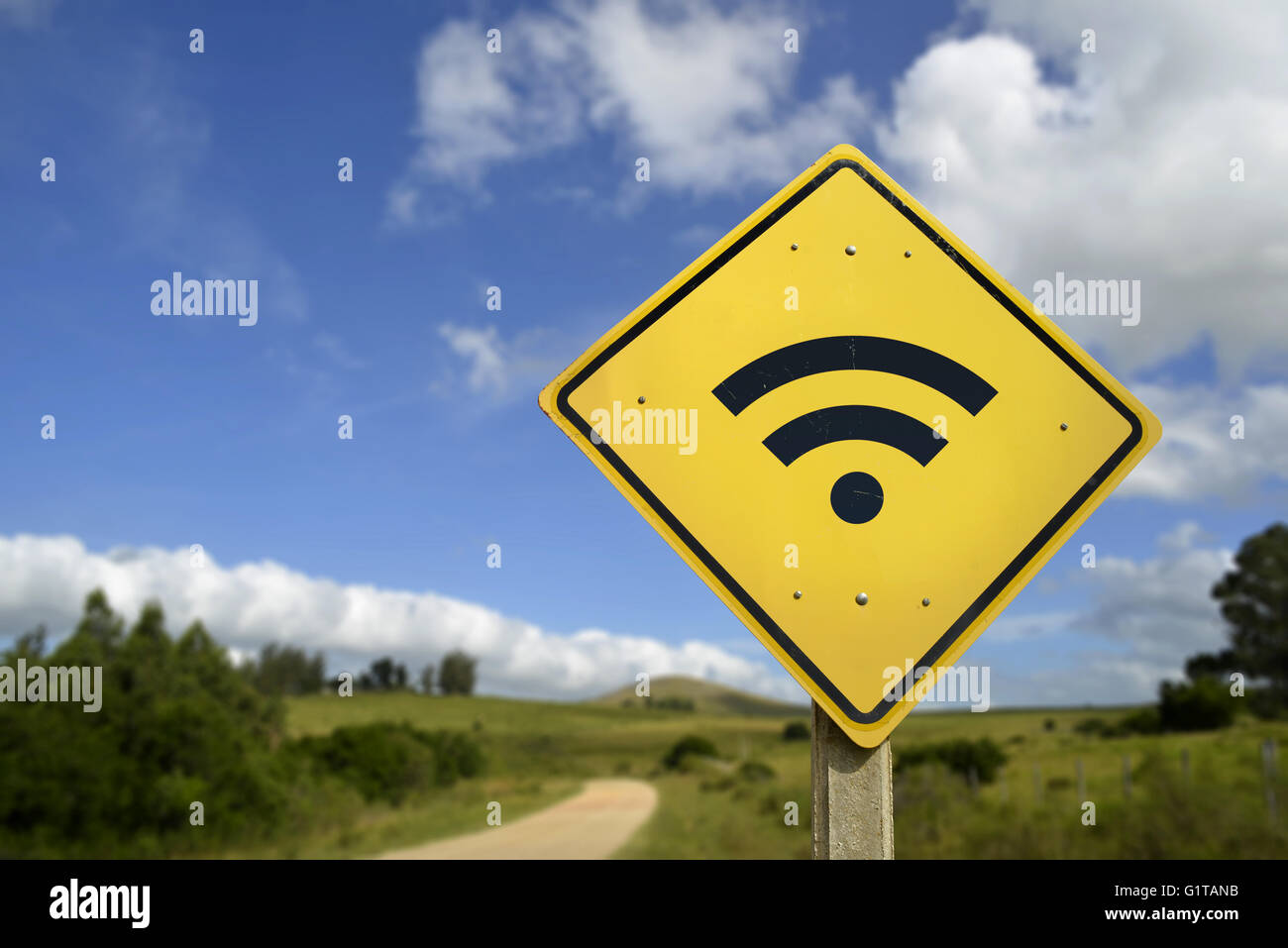 Internet access in remote zone, power of technology concept. Road sign with wifi signal icon on rural environment, includes copy Stock Photo