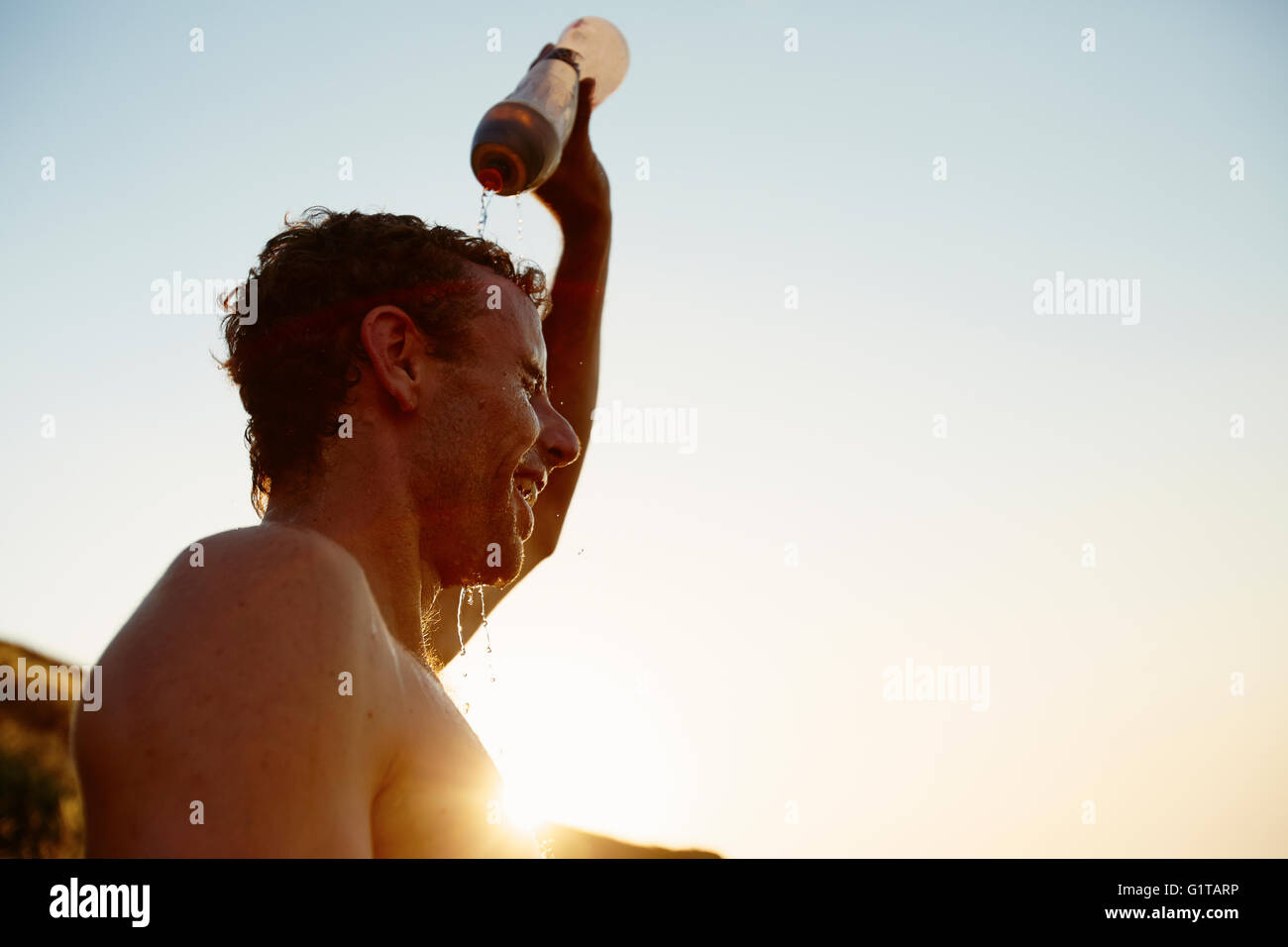 Tired runner pouring water on head Stock Photo Alamy