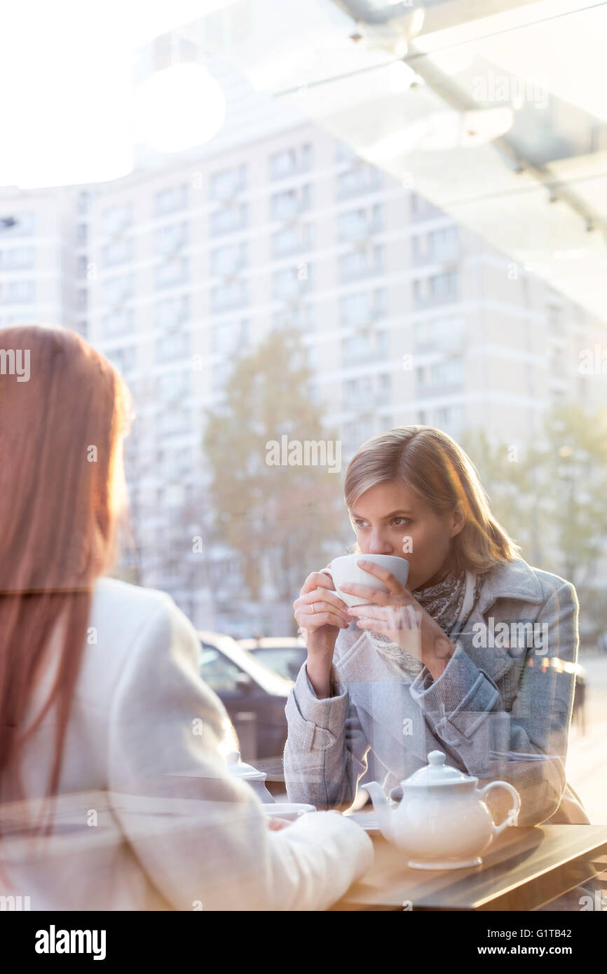 Women drinking tea at sidewalk cafe Stock Photo