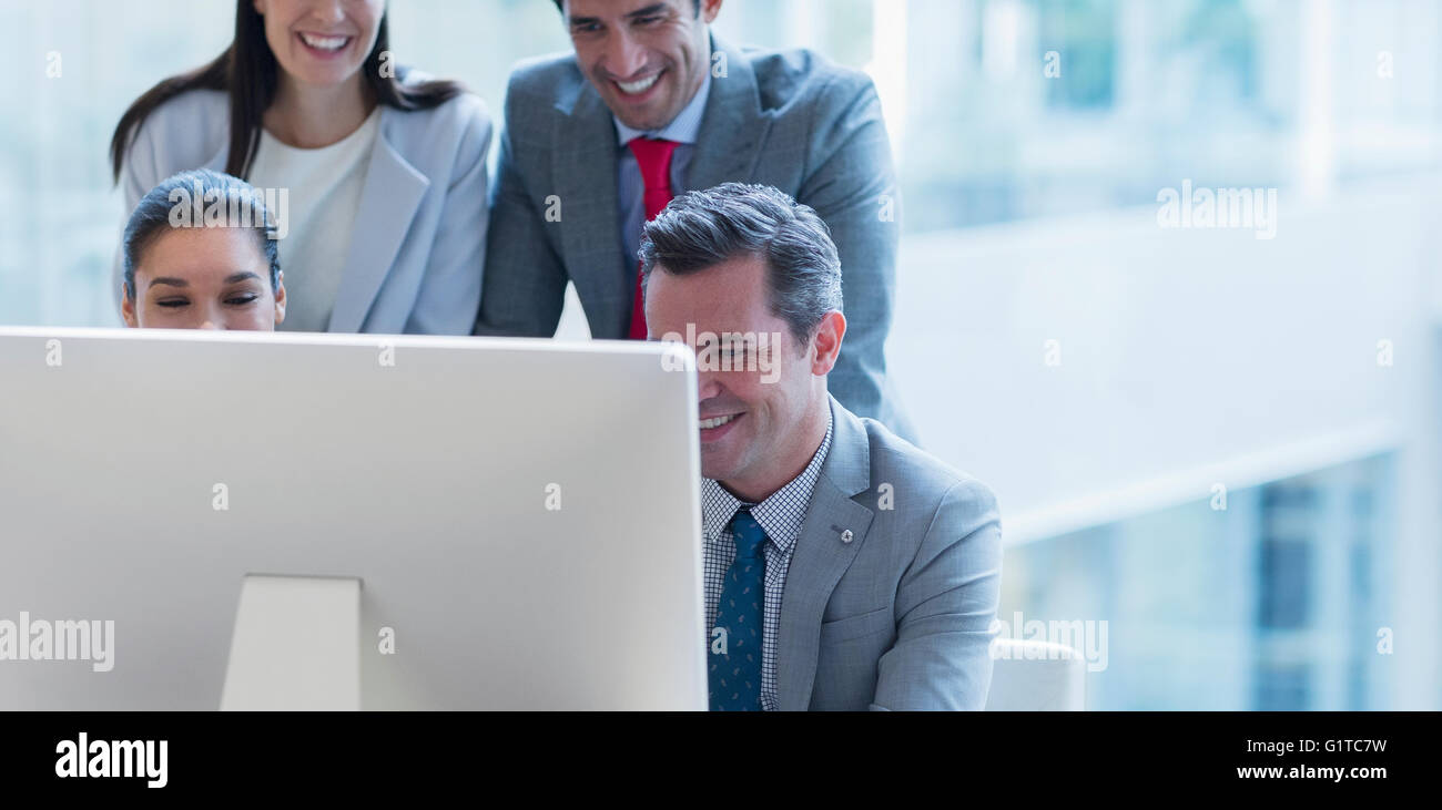 Business people working at computer in sunny office Stock Photo