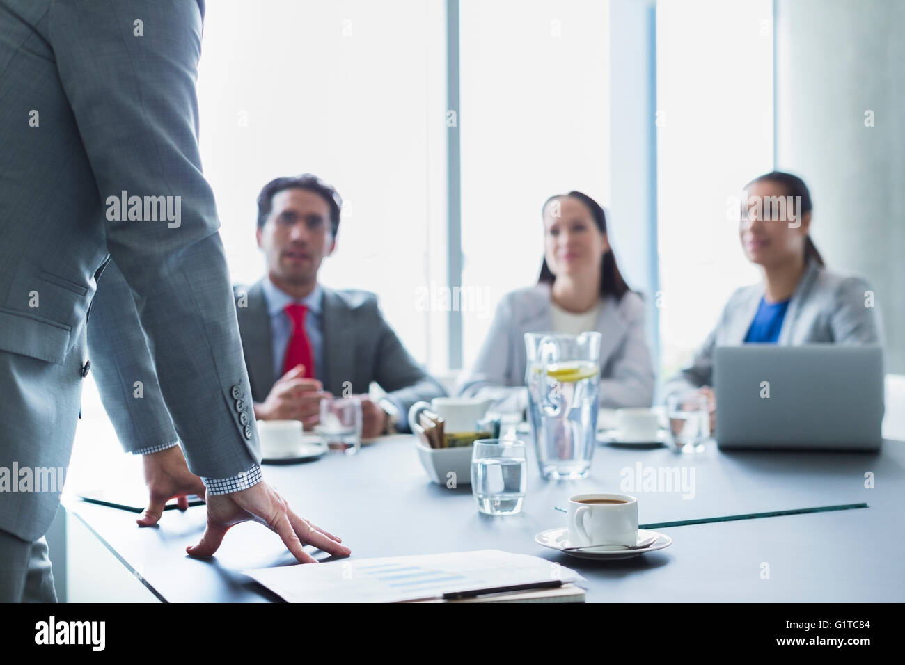 Businessman leading meeting in conference room Stock Photo