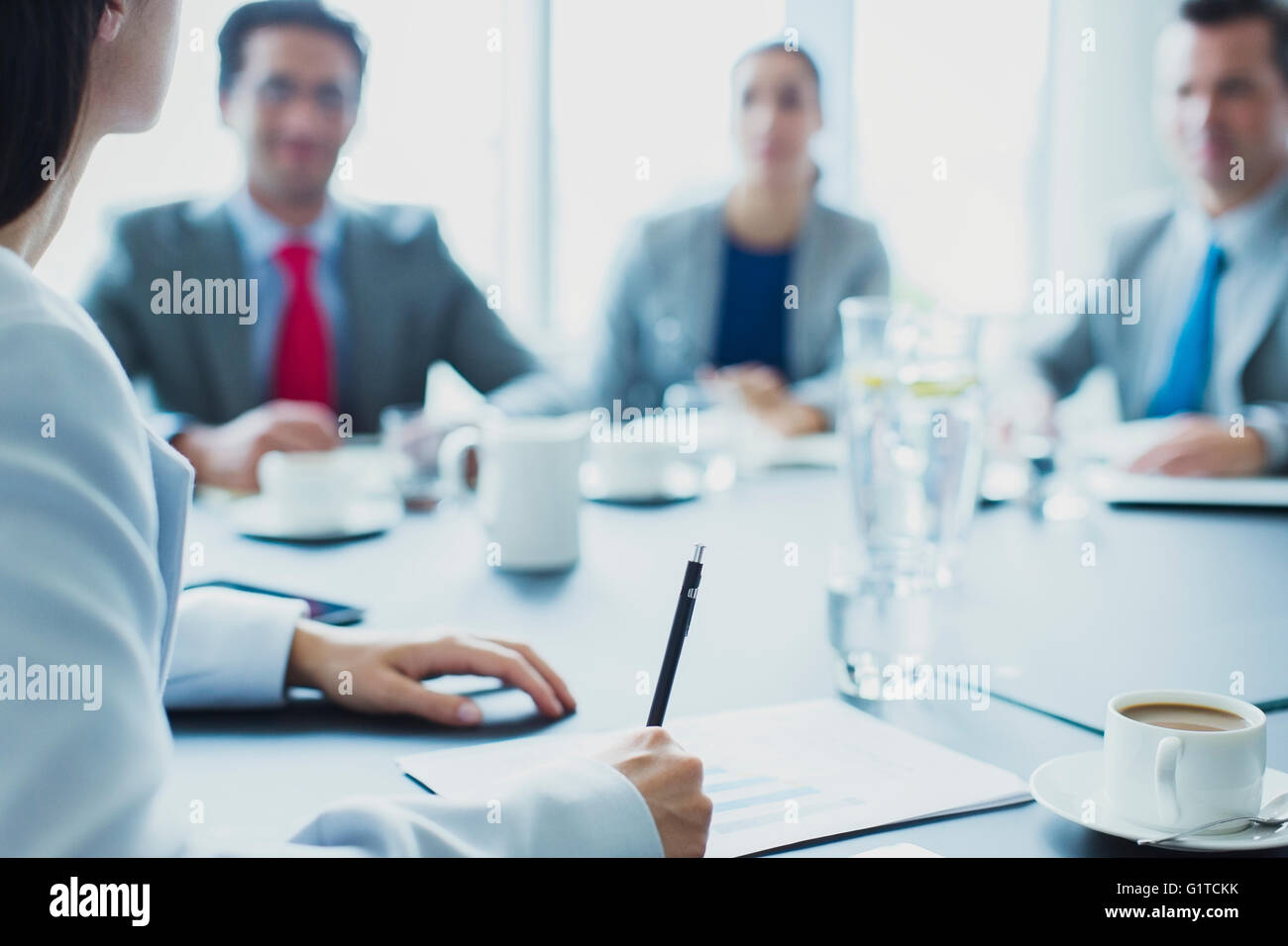 Businesswoman leading meeting in conference room Stock Photo