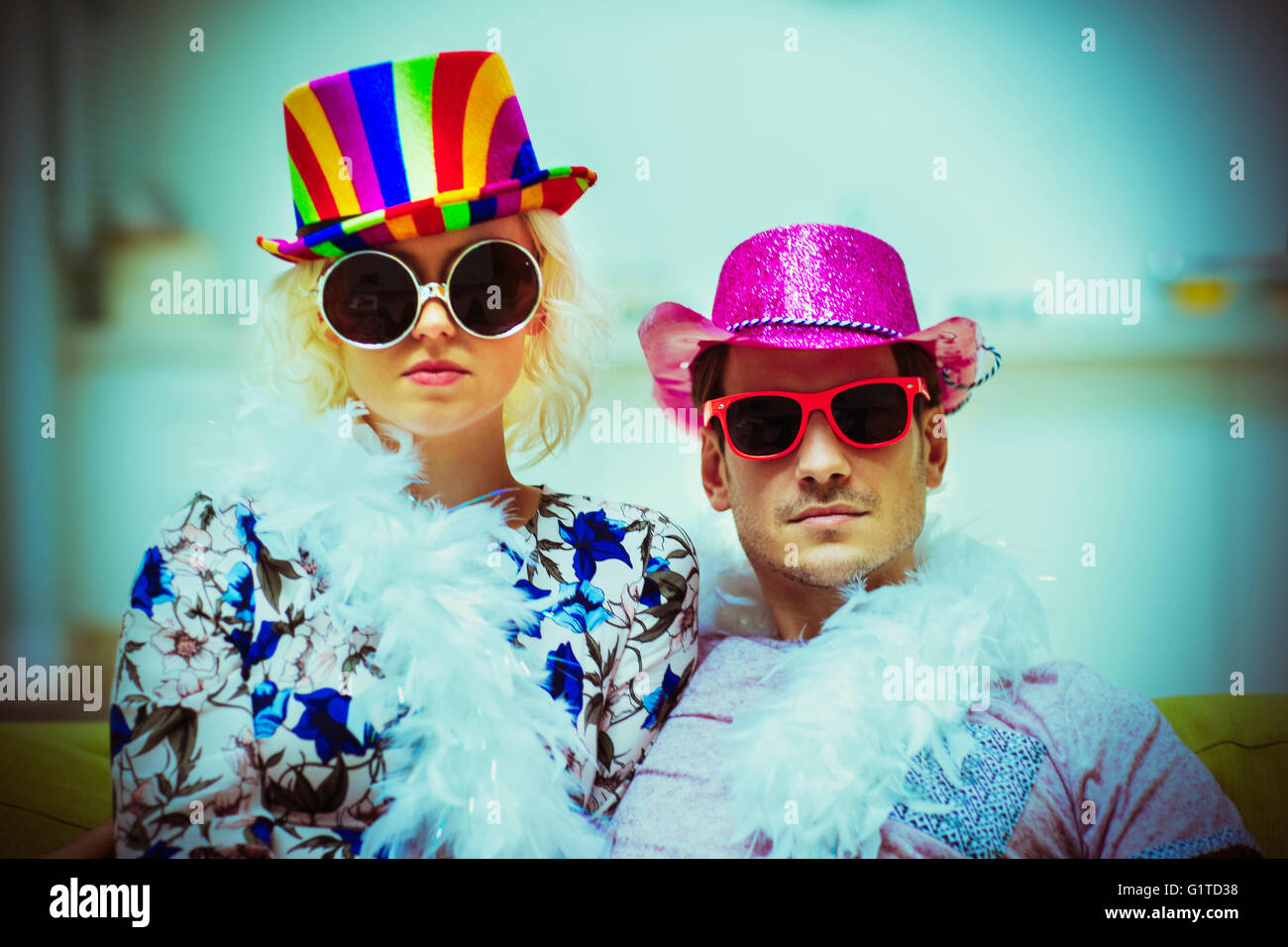 Portrait attitude couple wearing costume hats and sunglasses Stock Photo