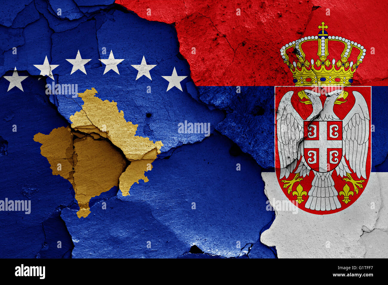 flags of Kosovo and Serbia painted on cracked wall Stock Photo