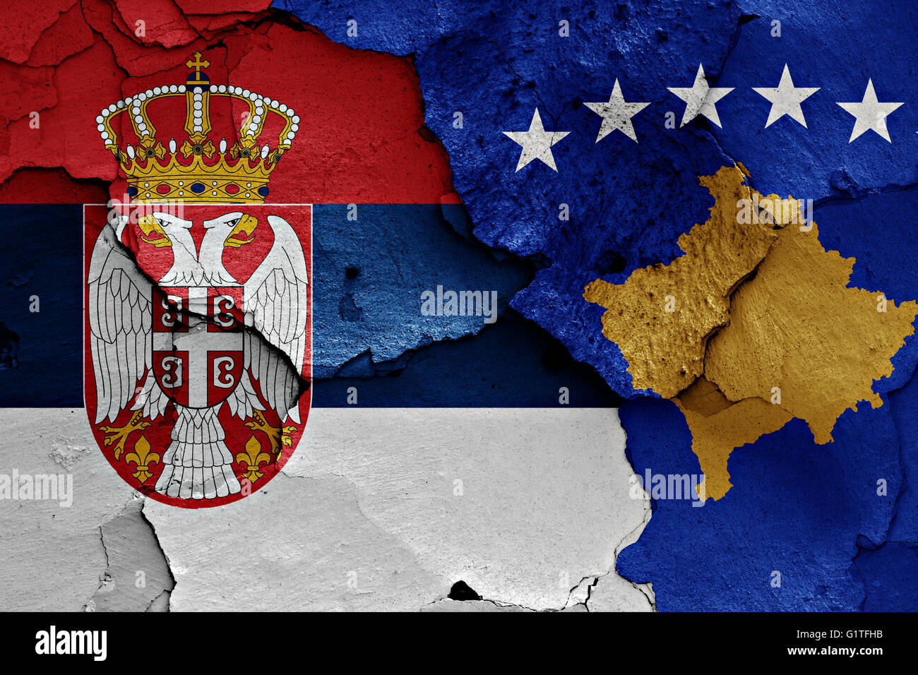 flags of Serbia and Kosovo painted on cracked wall Stock Photo
