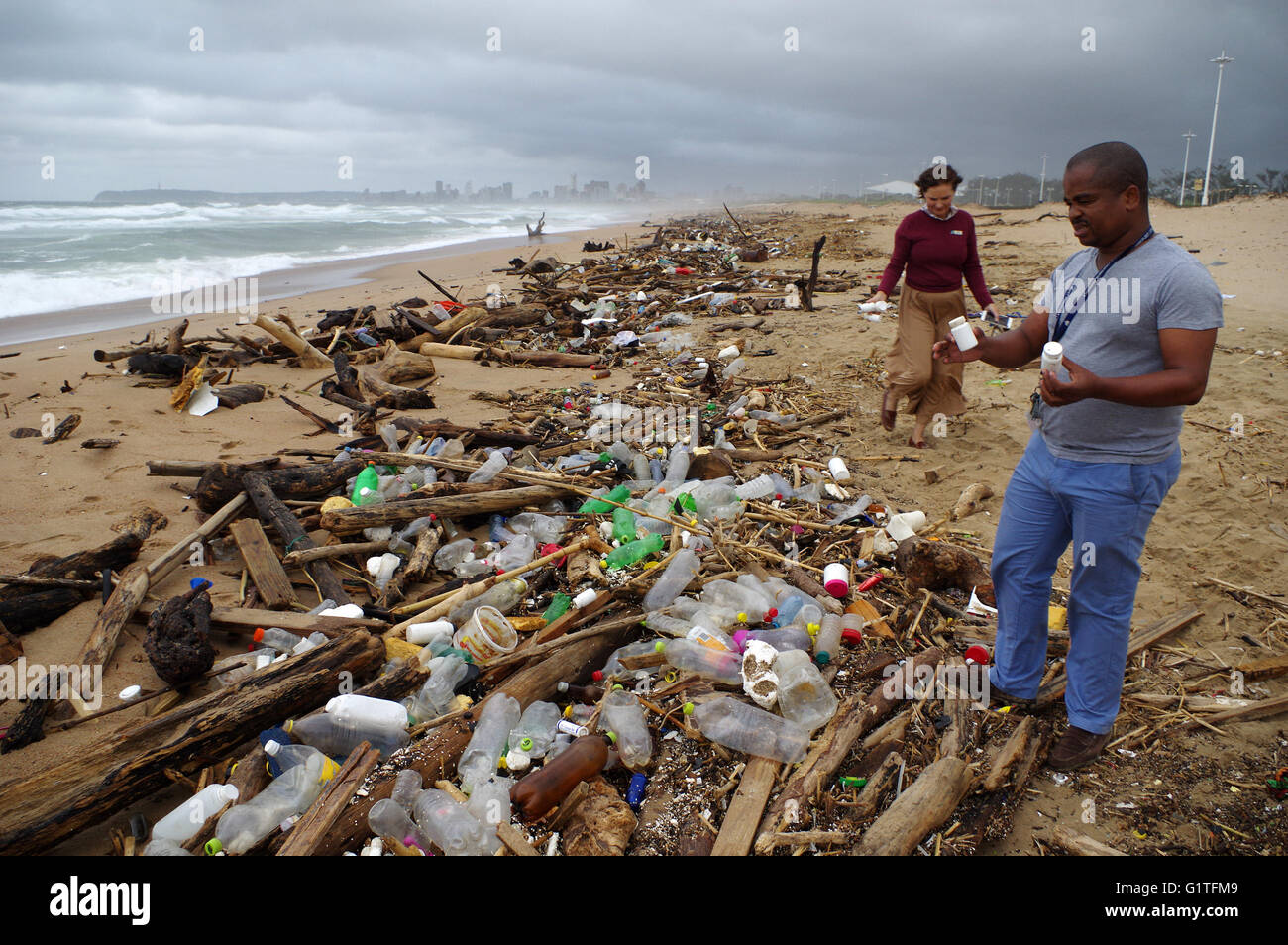 Durban, South Africa. 18th May, 2016. Khumbulani Dlongolo, the eThekwini Metro Municipality's acting manager responsible for beaches inspects some of the medical waste that was found on the Blue Lagoon Beach next to the mouth of the Umgeni River. The waste, which consisted primarily of tablets and sealed condoms, was found in among the debris littering the beach that had been cast ashore with recent heavy rains. Credit:  Giordano Stolley/Alamy Live News Stock Photo