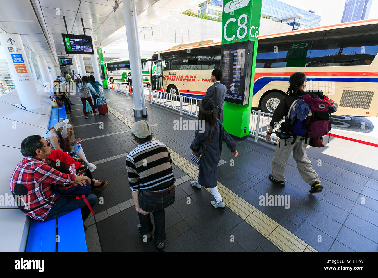 Passengers walk around the departure area of the Shinjuku Expressway Bus Terminal on May 18