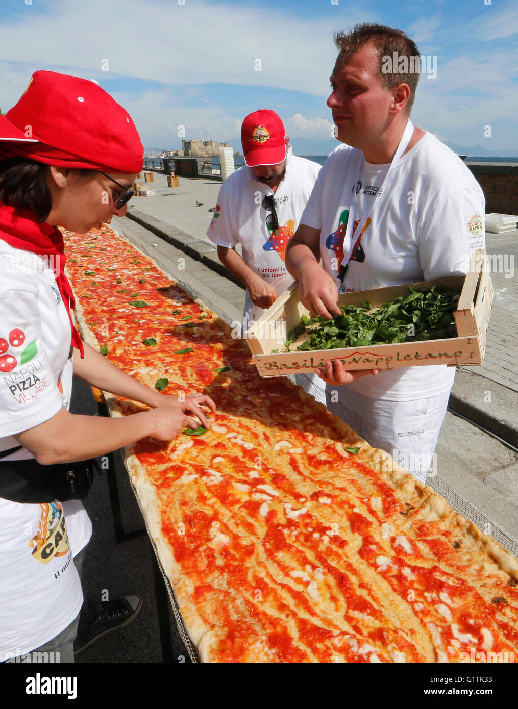 Naples, Italy. 18th May, 2016. Pizza makers attemps to break the world record of the longest pizza in the world on seafront of Naples 18 may 2016  to make it the 1,8 kilometers of baked wood-fired pizza for which were used: 2,000 kg of flour, 1600 kg of tomatoes, 2,000 kg of mozzarella, 200 liters of oil and 1500 liters of water. Credit:  agnfoto/Alamy Live News Stock Photo