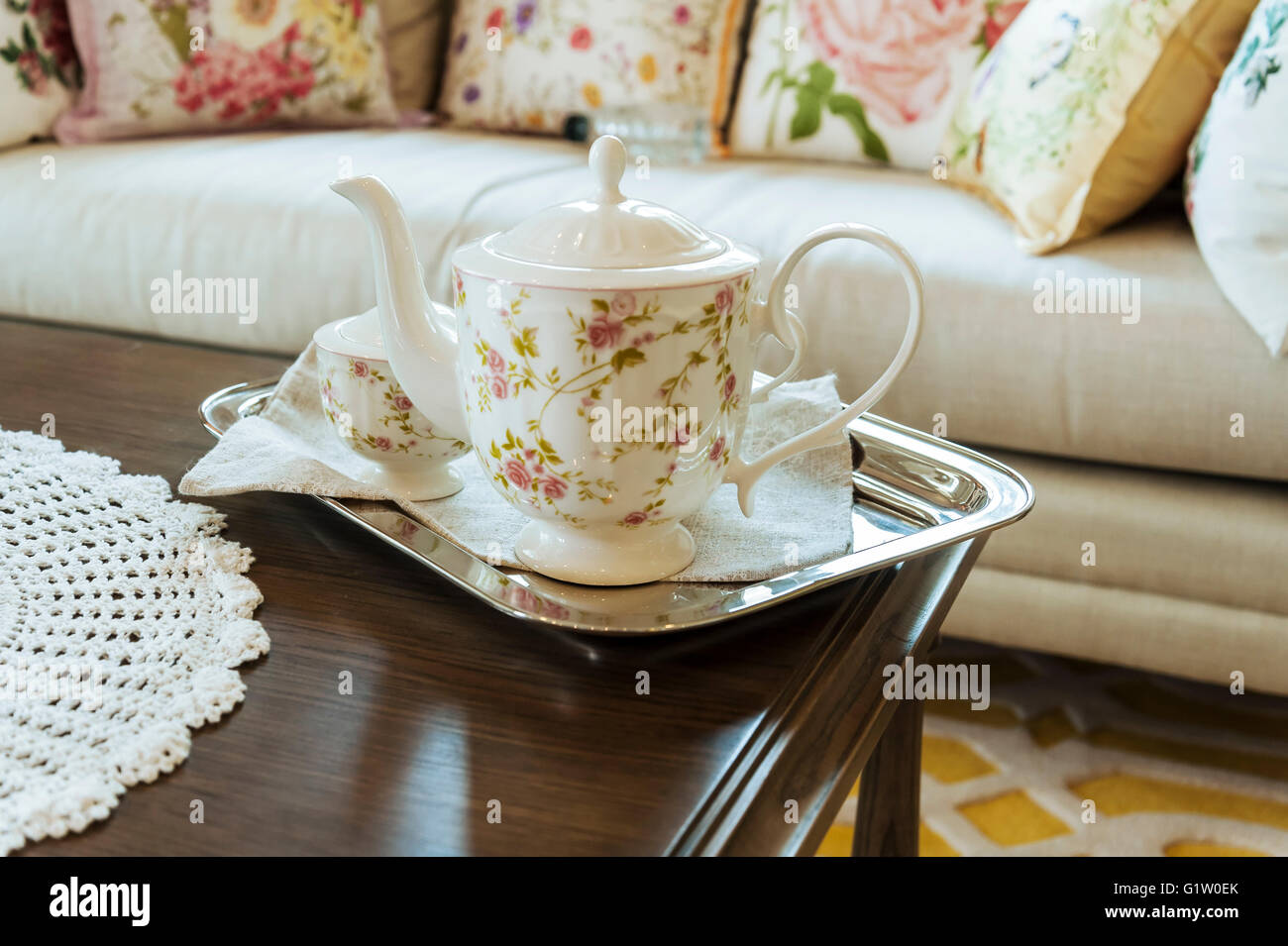 ceramic teapot and cups on a stainless steel tray in living room Stock