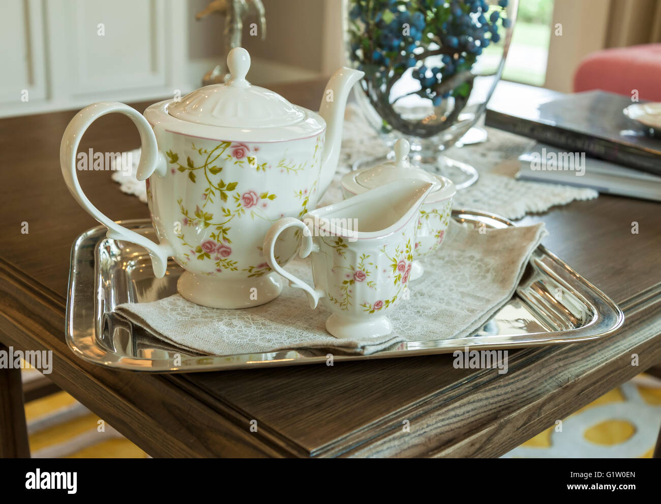 ceramic teapot and cups on a stainless steel tray in living room Stock