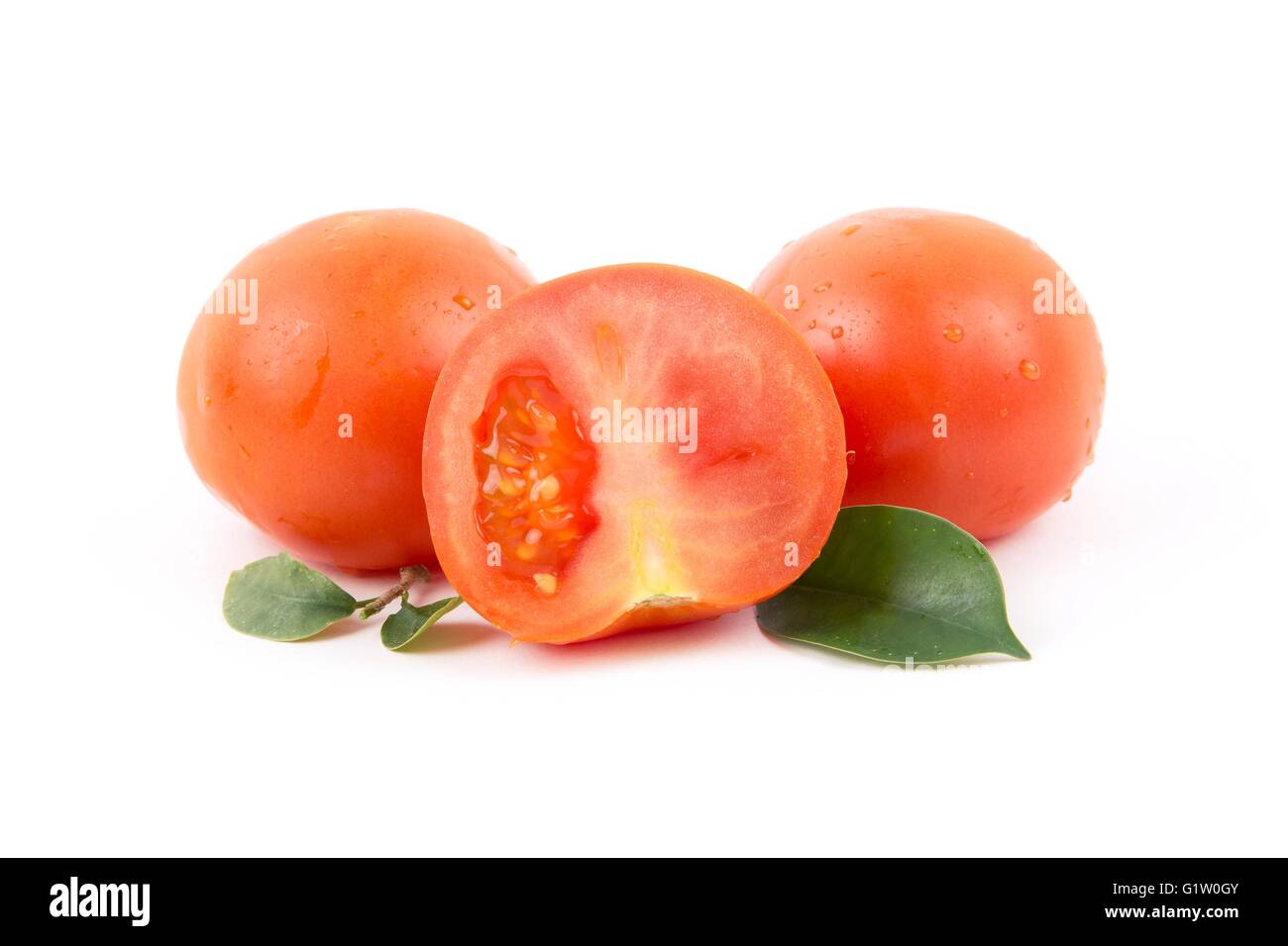 Fresh tomatos with leaves on a white background Stock Photo - Alamy