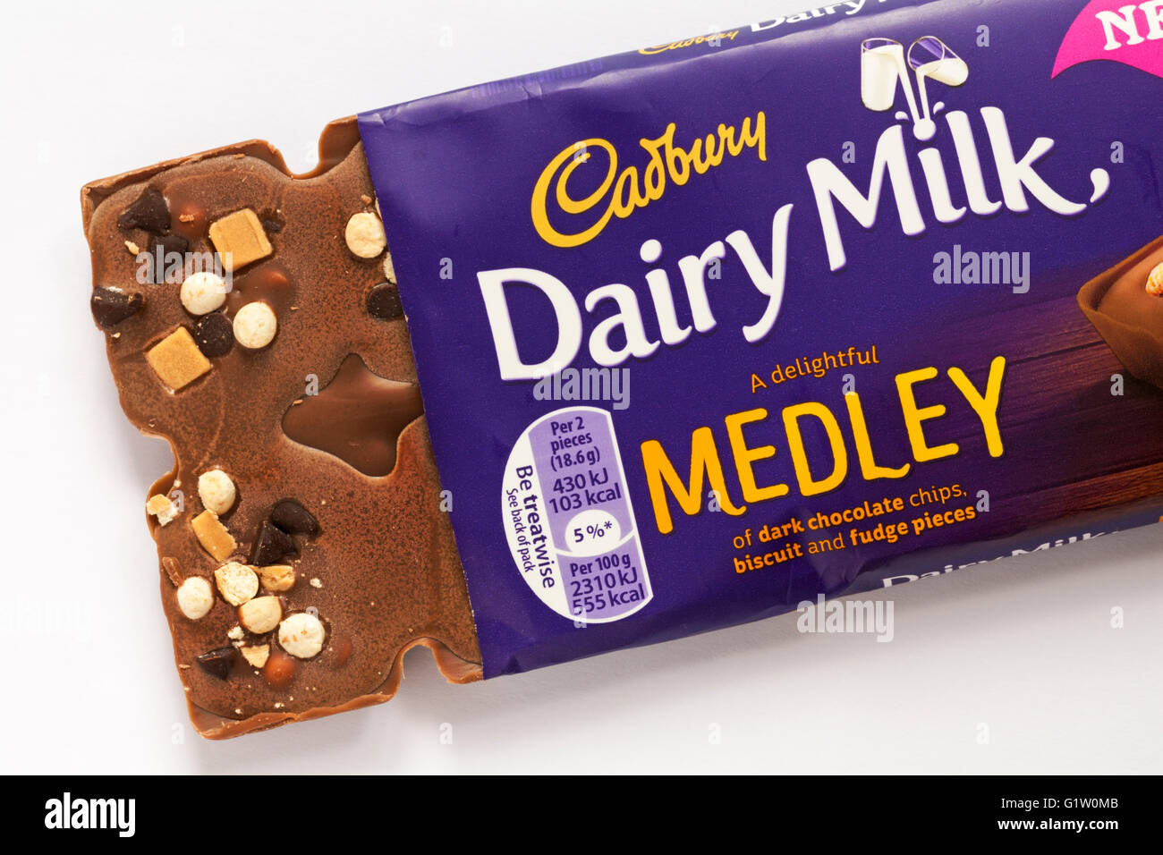 Opened Cadbury Dairy Milk Medley chocolate bar - a delightful medley of dark chocolate chips biscuit and fudge pieces set on white background Stock Photo
