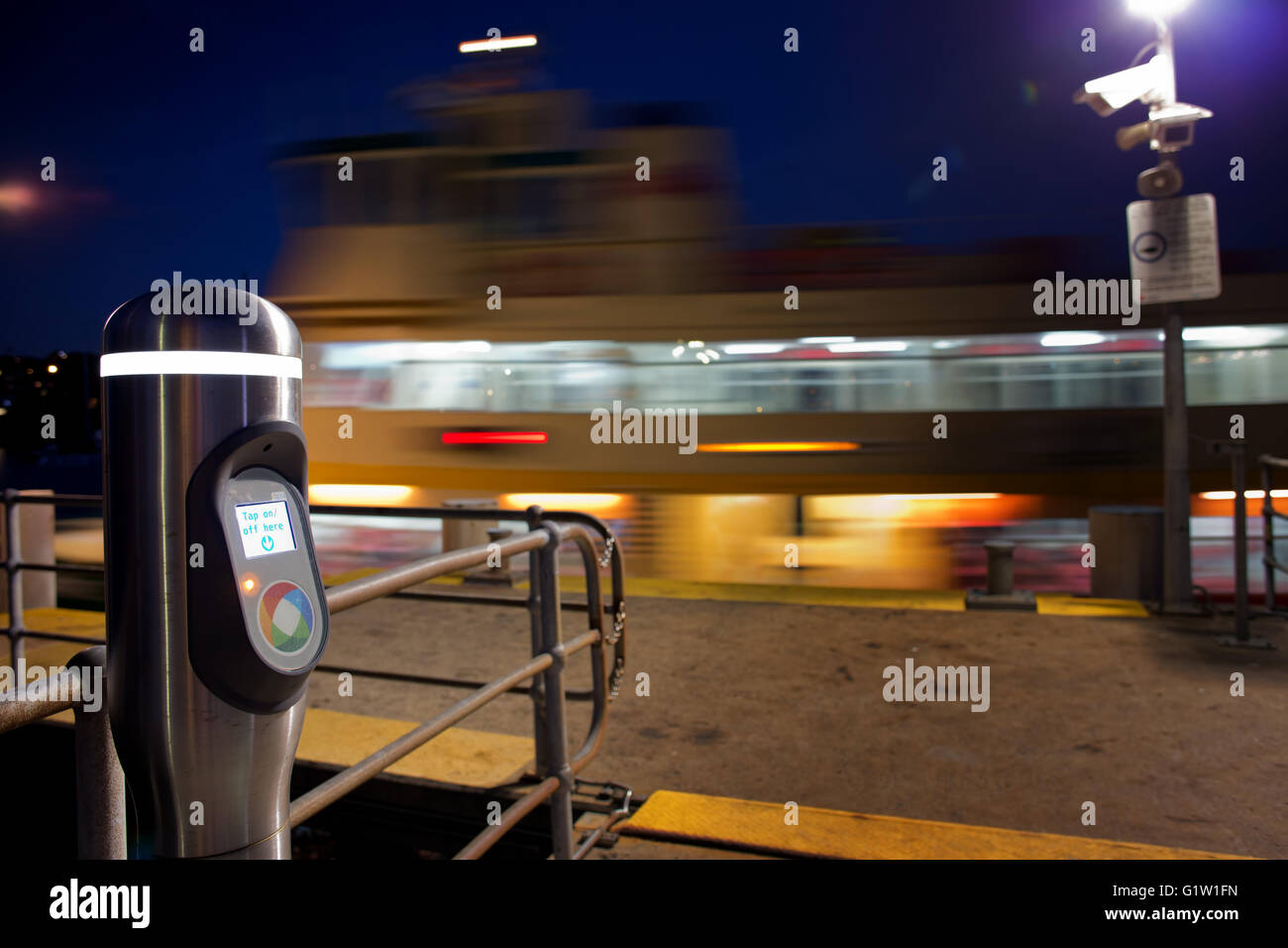 Motion blur shot of a Sydney ferry and an Opal Card reader at night. Stock Photo