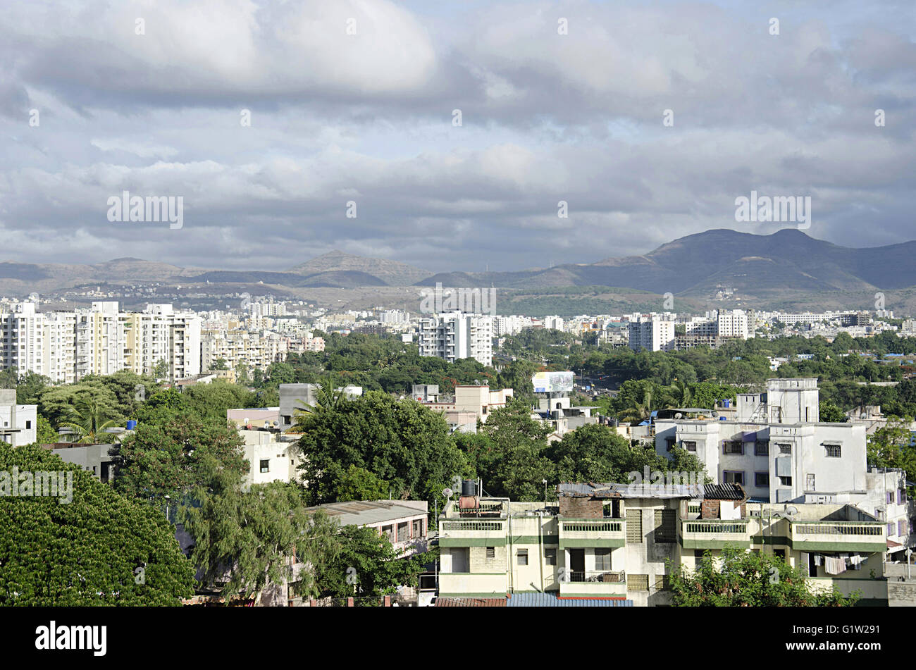 View of buildings and mountains, Cloudy sky, Warje, Pune, Maharashtra, India Stock Photo
