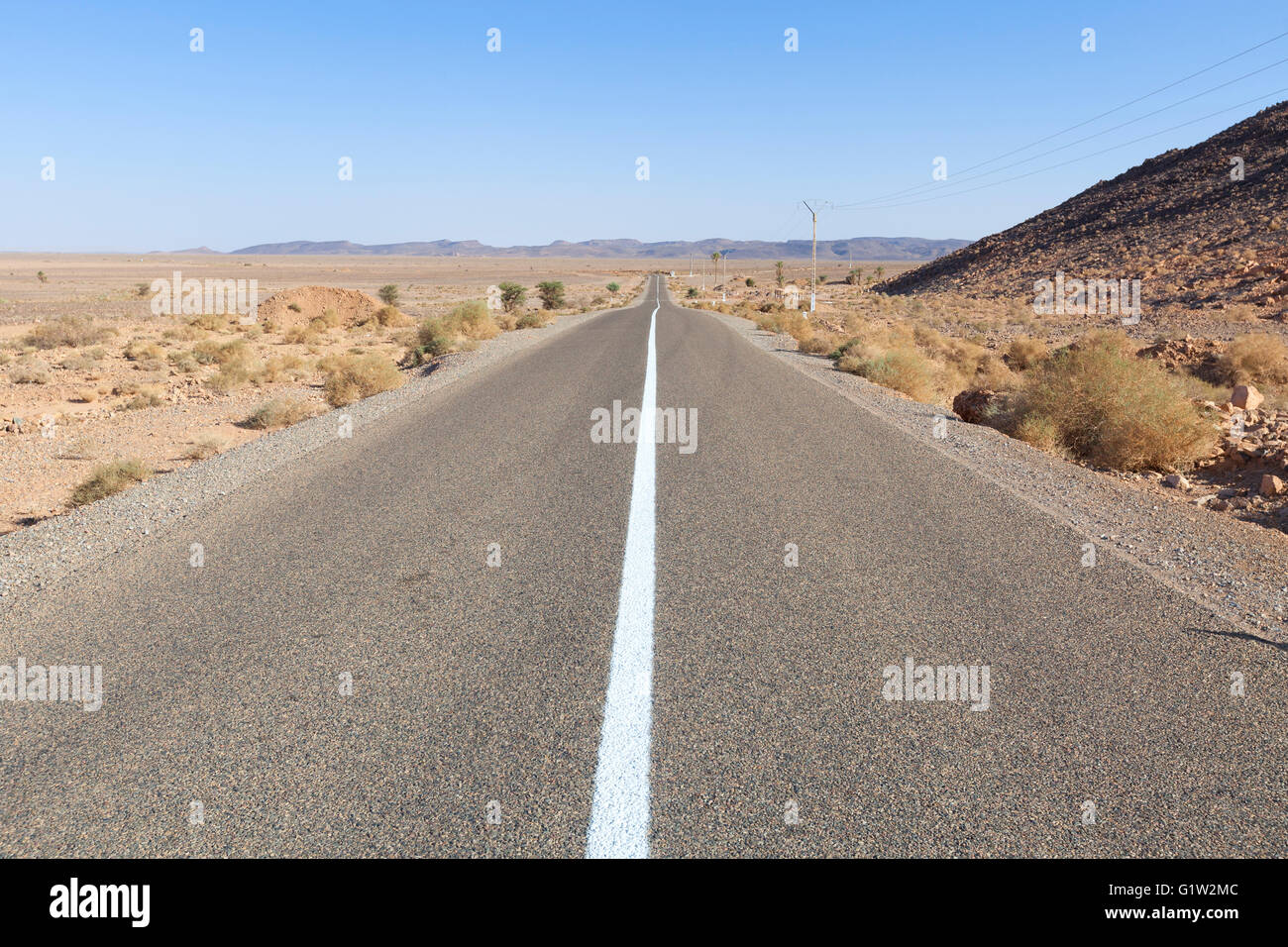 Straight road with blue sky in southern Morocco Stock Photo