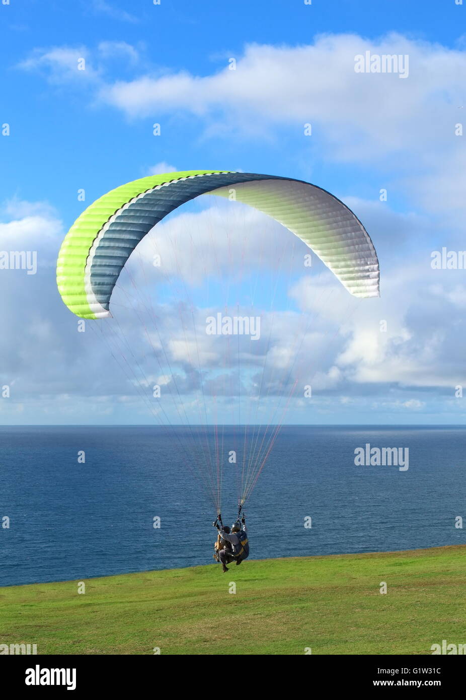 Hang Glider Hang Glider flying over the beach at glide port Stock