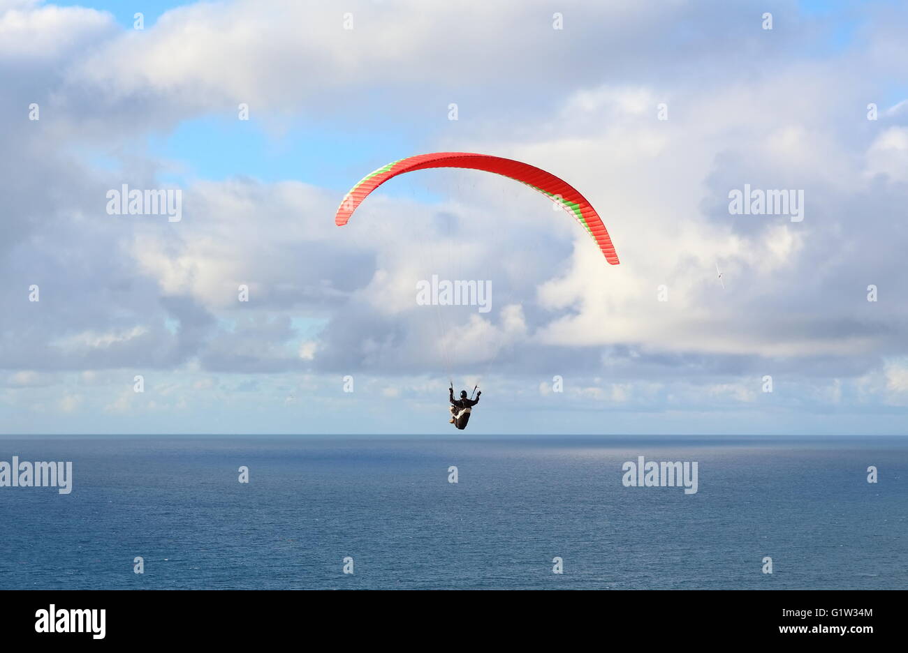 Hang Glider – Hang Glider flying in the sky on a bright blue day Stock Photo