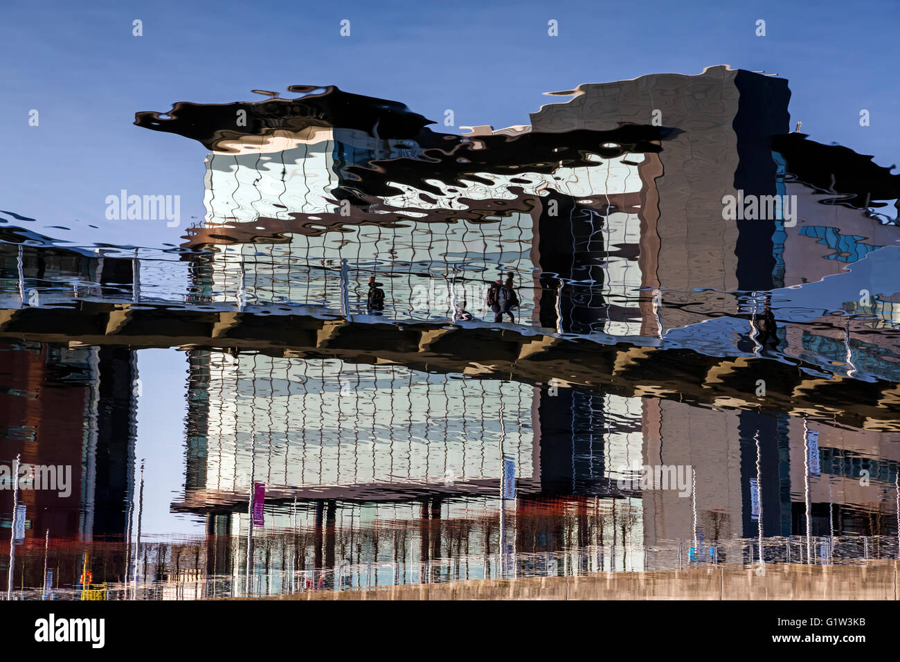 Abstract view of the Tradeston pedestrian bridge reflected in the River Clyde in Glasgow city centre, Scotland, UK Stock Photo