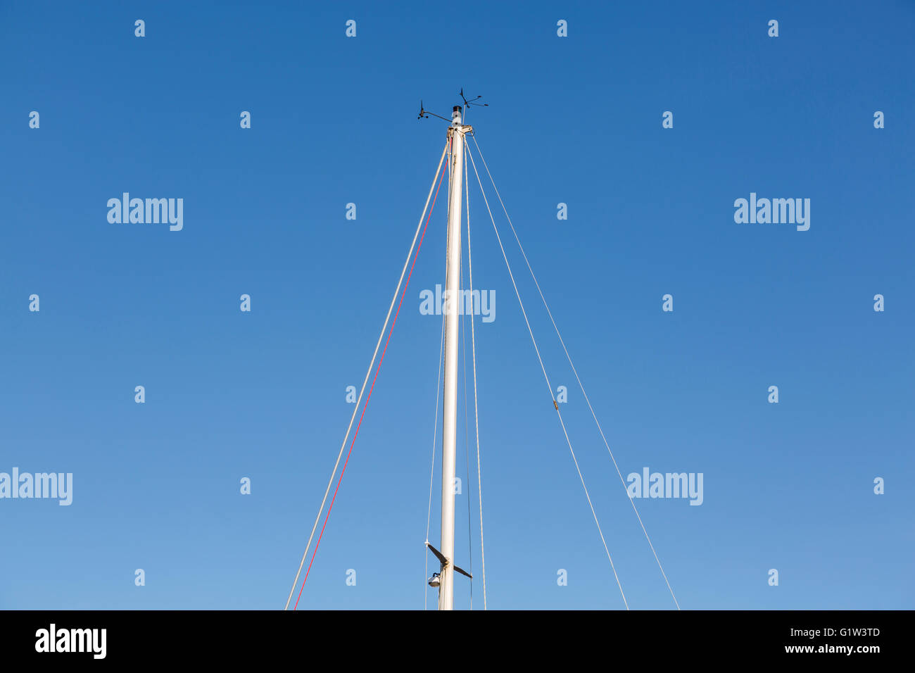 A boat sailing mast against a clear blue sky Stock Photo