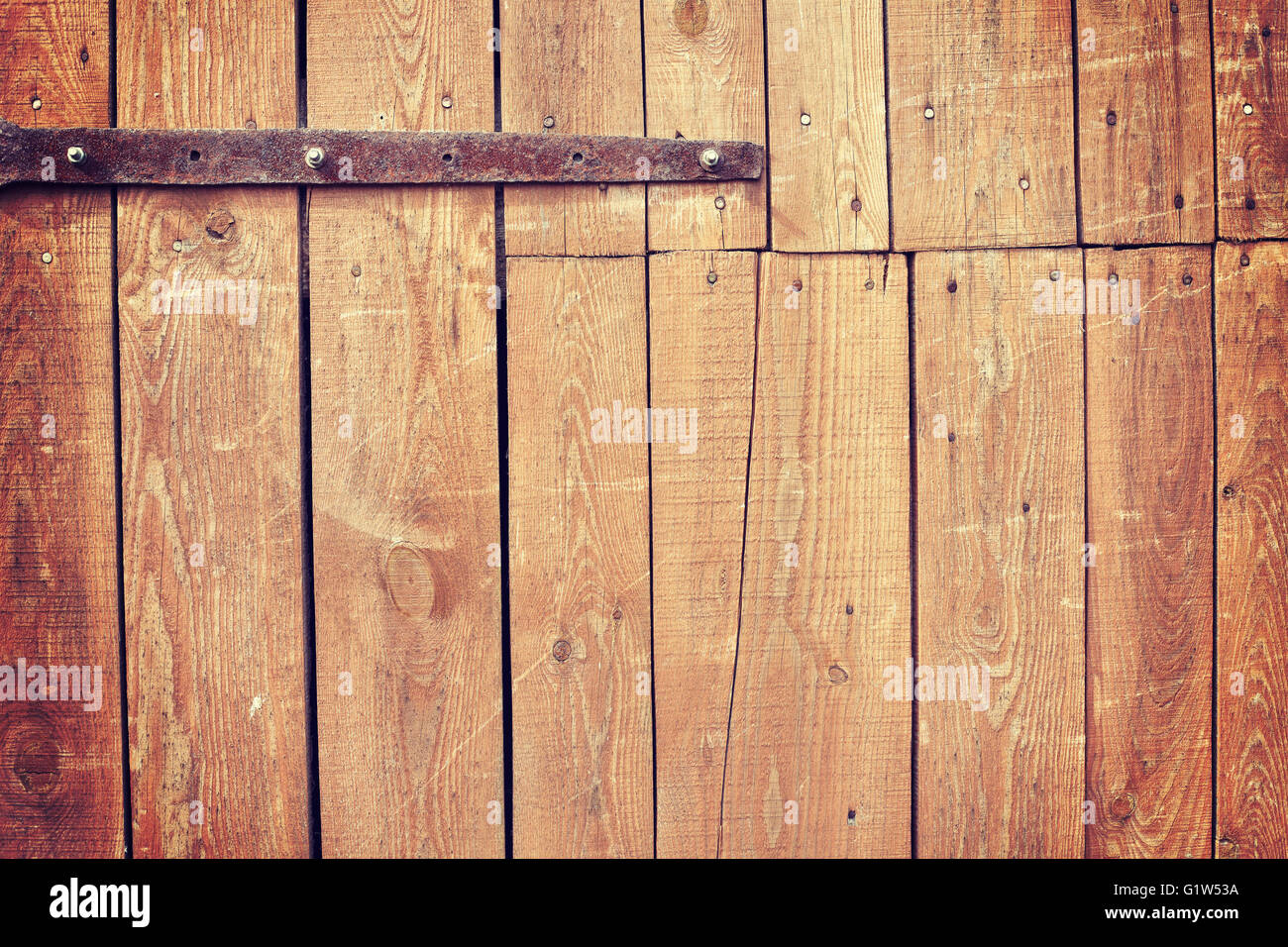 Vintage toned old wooden barn door background. Stock Photo