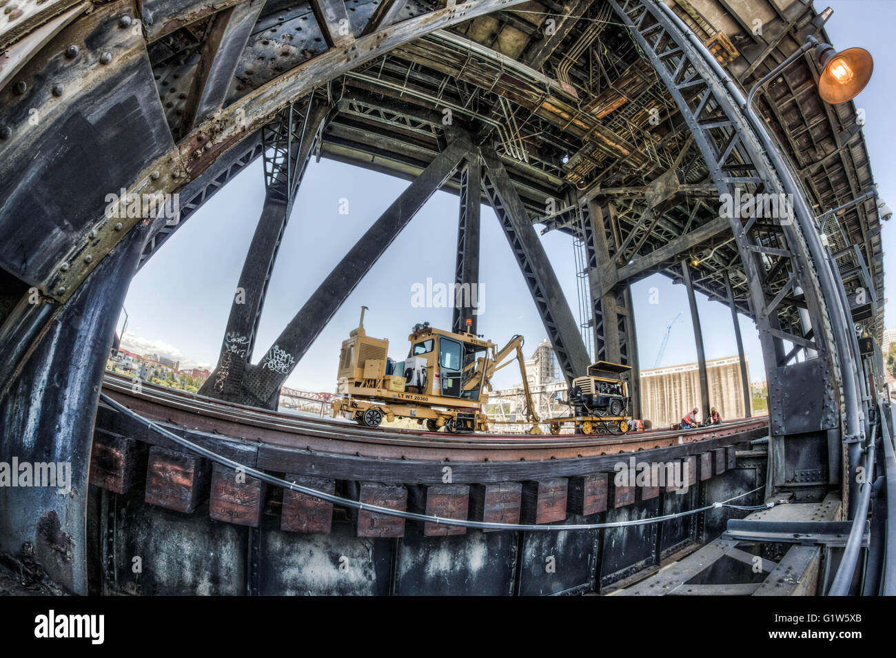 Work being done on the rail under a steel bridge Stock Photo