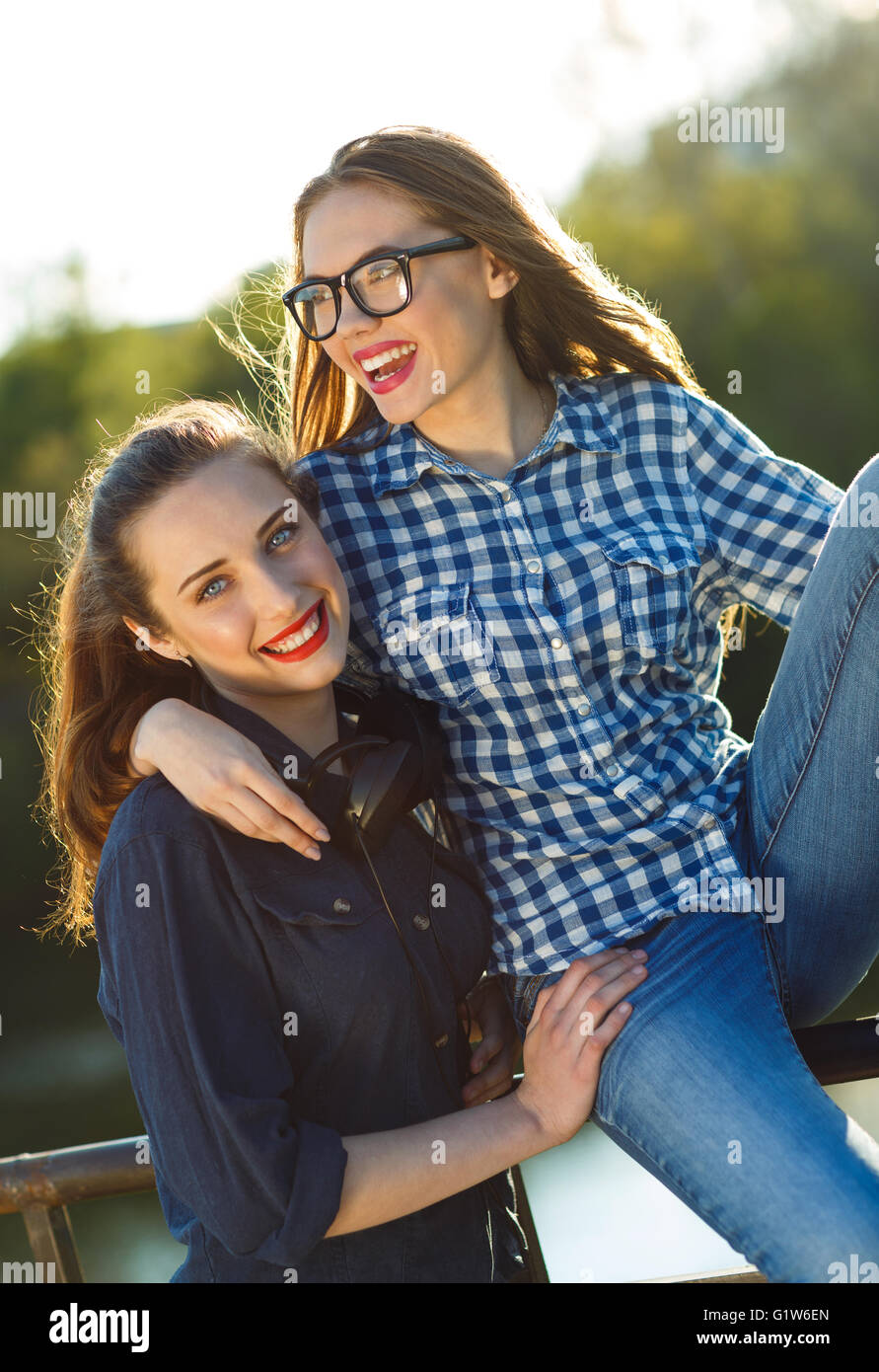 Two playful young women having fun outdoors at sunset light Stock Photo ...