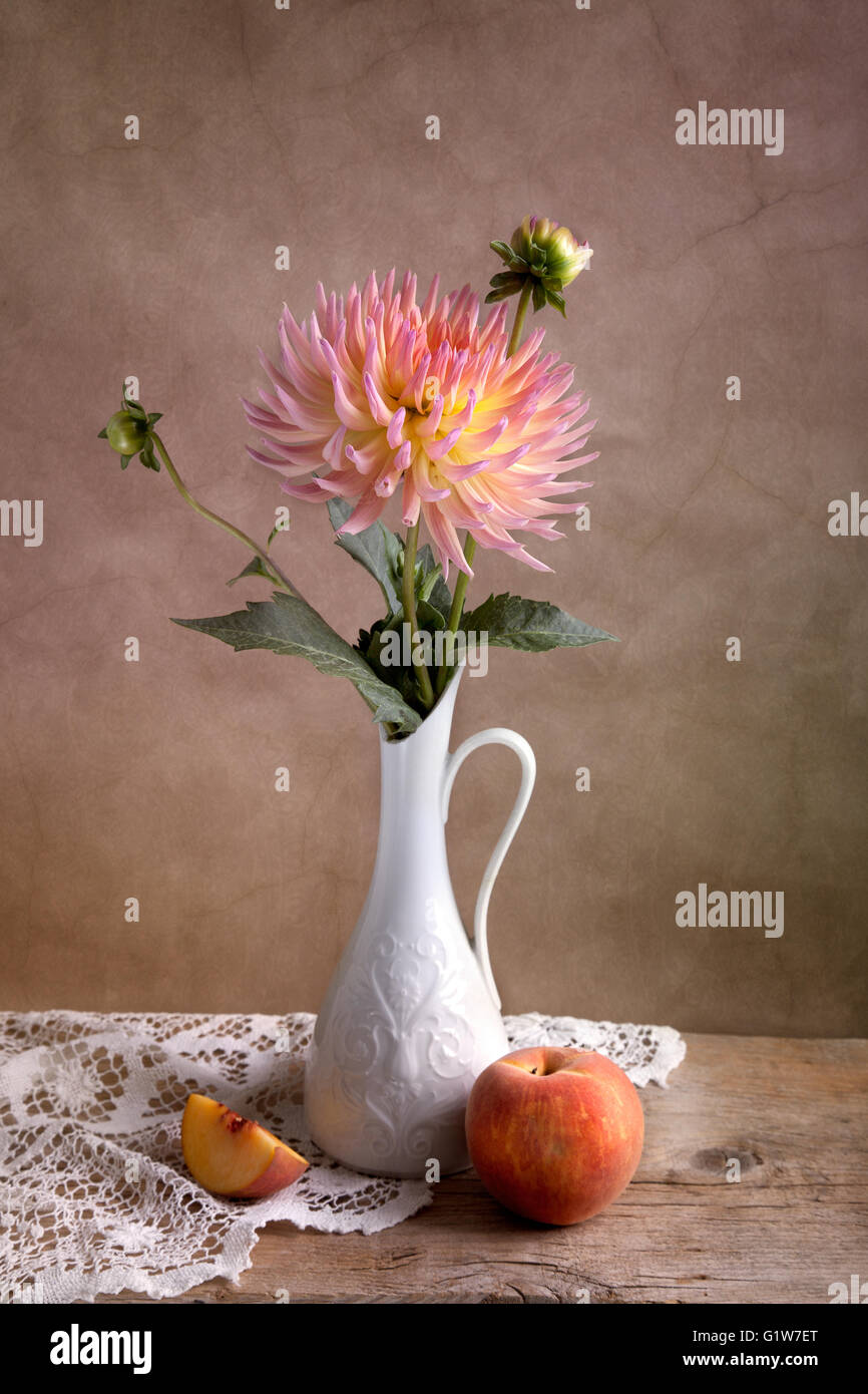 Dahlia Flowers in Vase with Peach fruit Stock Photo Alamy