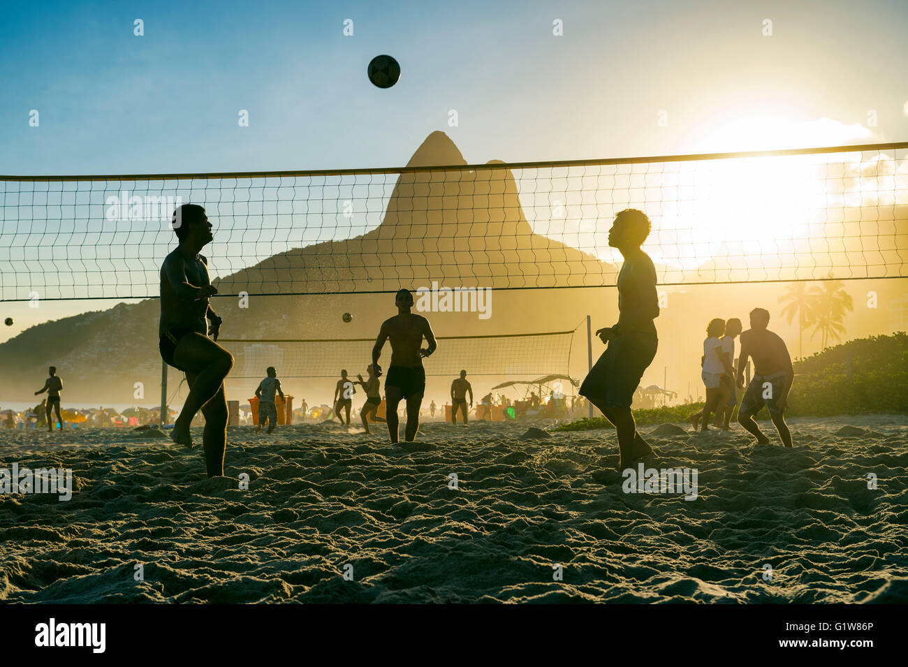 Silhouettes of Brazilians playing futevolei (footvolley) on Ipanema Beach in Rio de Janeiro, Brazil Stock Photo