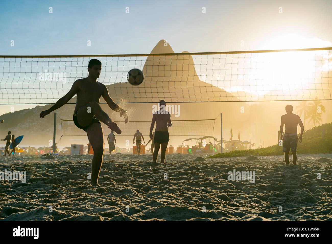 Silhouettes of Brazilians playing futevolei (footvolley) on Ipanema Beach in Rio de Janeiro, Brazil Stock Photo