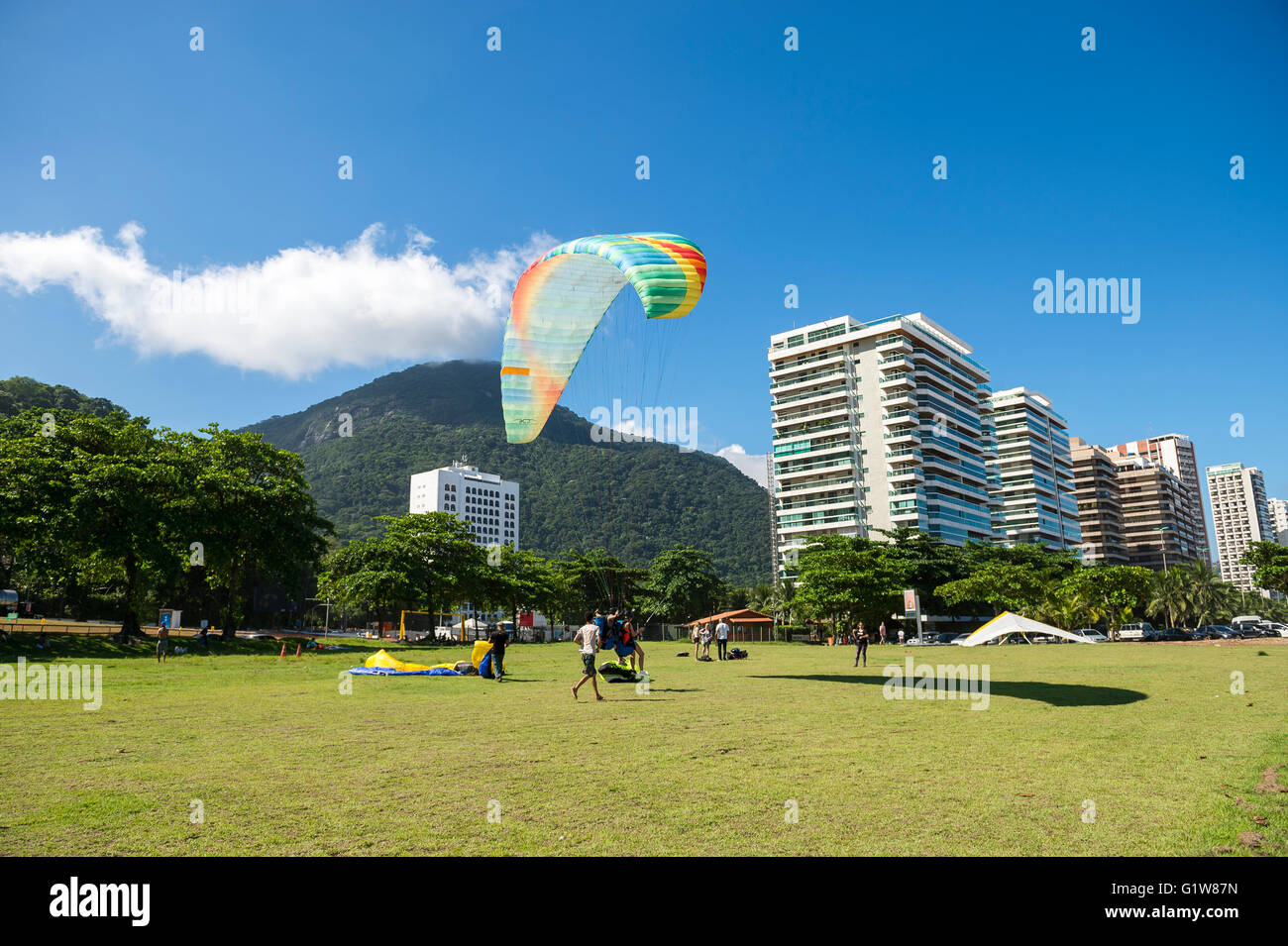 RIO DE JANEIRO - MARCH 19, 2016: Paraglider lands on the landing field beside the beach at Sao Conrado. Stock Photo