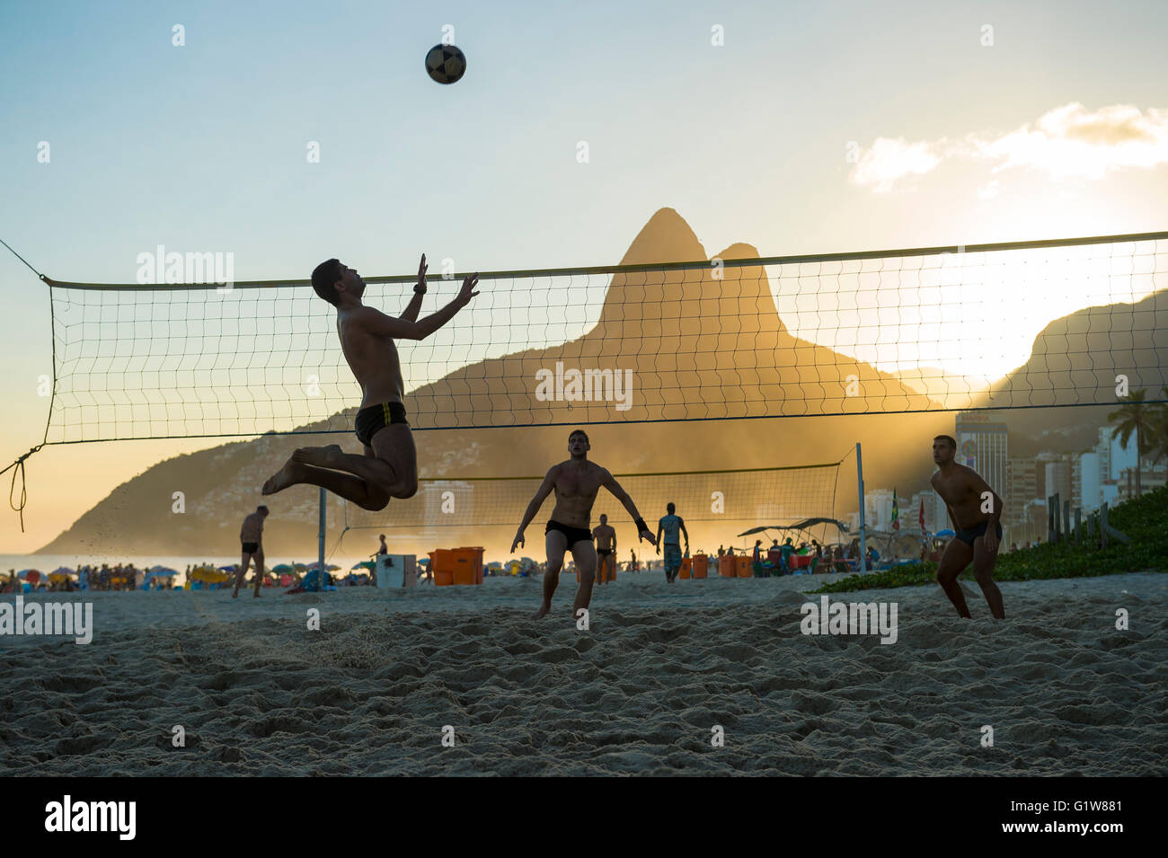 RIO DE JANEIRO - MARCH 27, 2016: Brazilians play beach futevôlei (footvolley, a sport combining football/soccer and volleyball). Stock Photo
