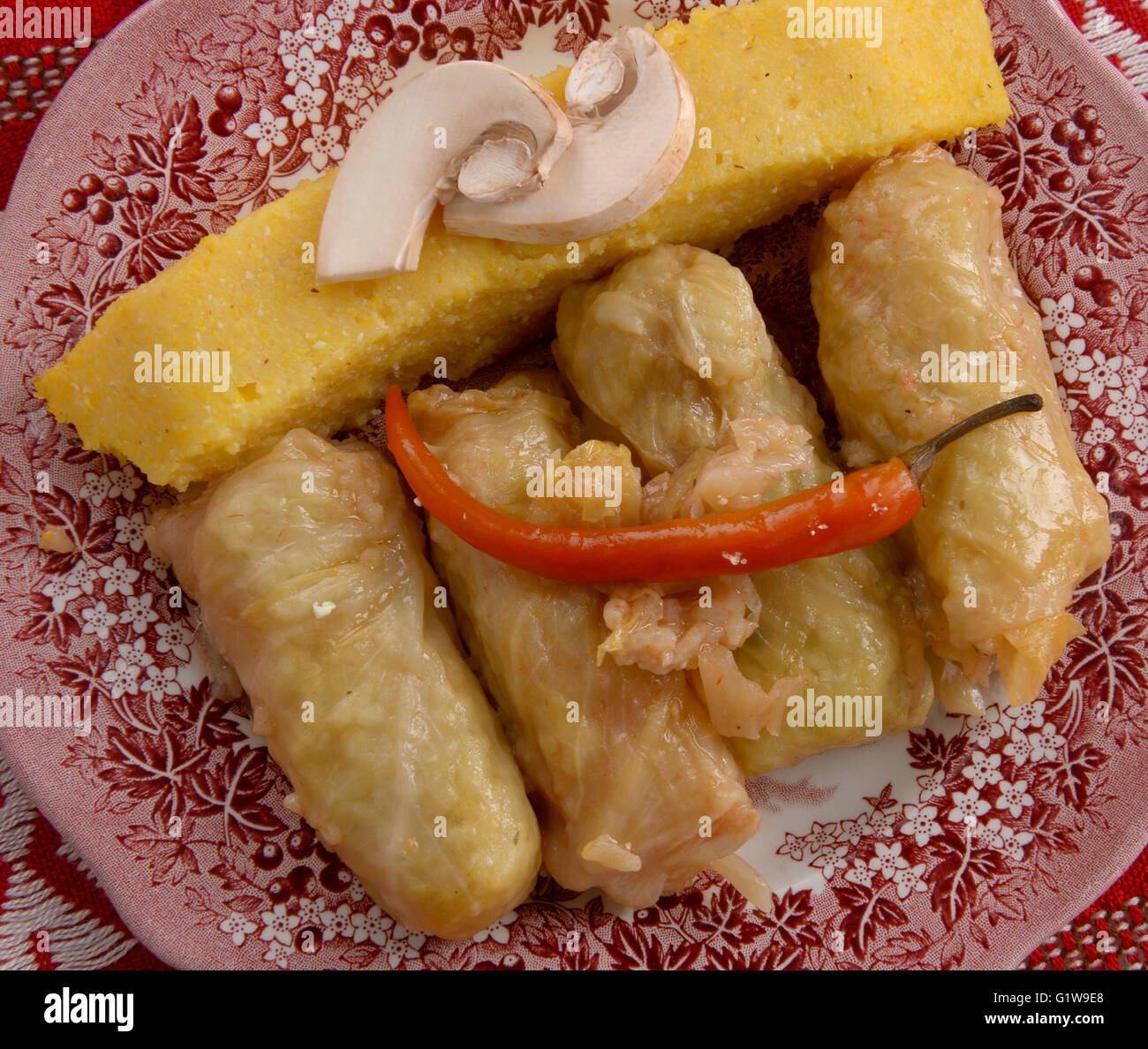 polenta and sarmale cabbage rolls filled with rice on a plate Stock Photo