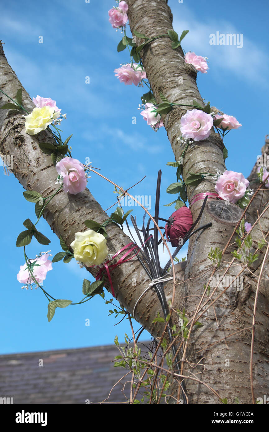 Tree Dressing a tree in Presteigne Powys Wales decorated with artificial flowers at Easter Stock Photo