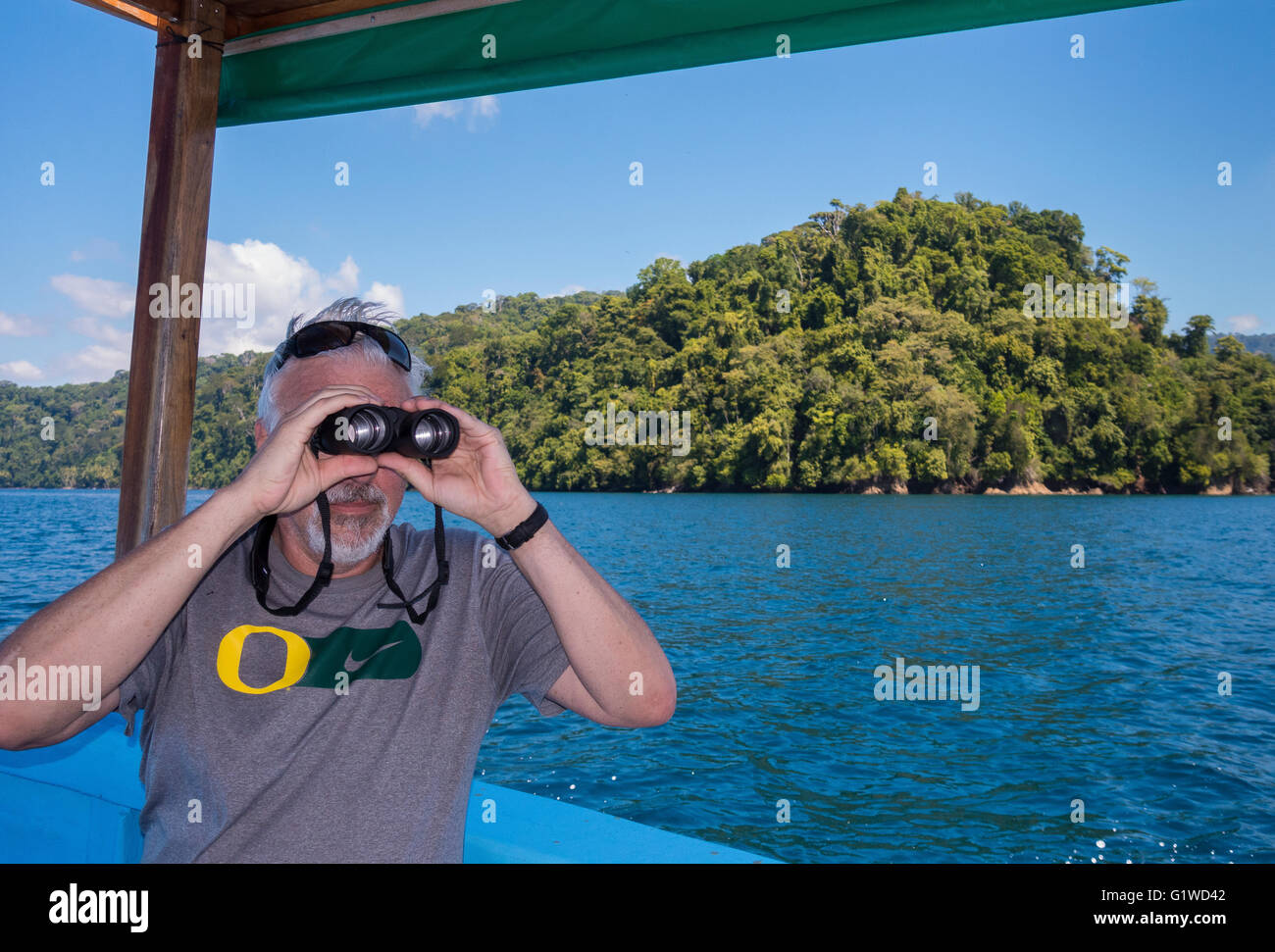 GULFO DULCE, COSTA RICA Man looks with binoculars, and Piedras