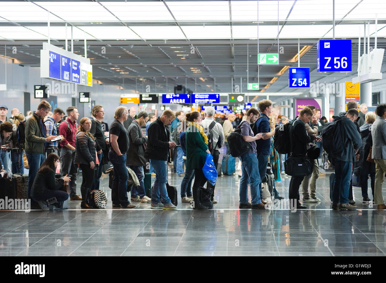 Passengers waiting in a row for boarding on an airport to a flight to America Stock Photo