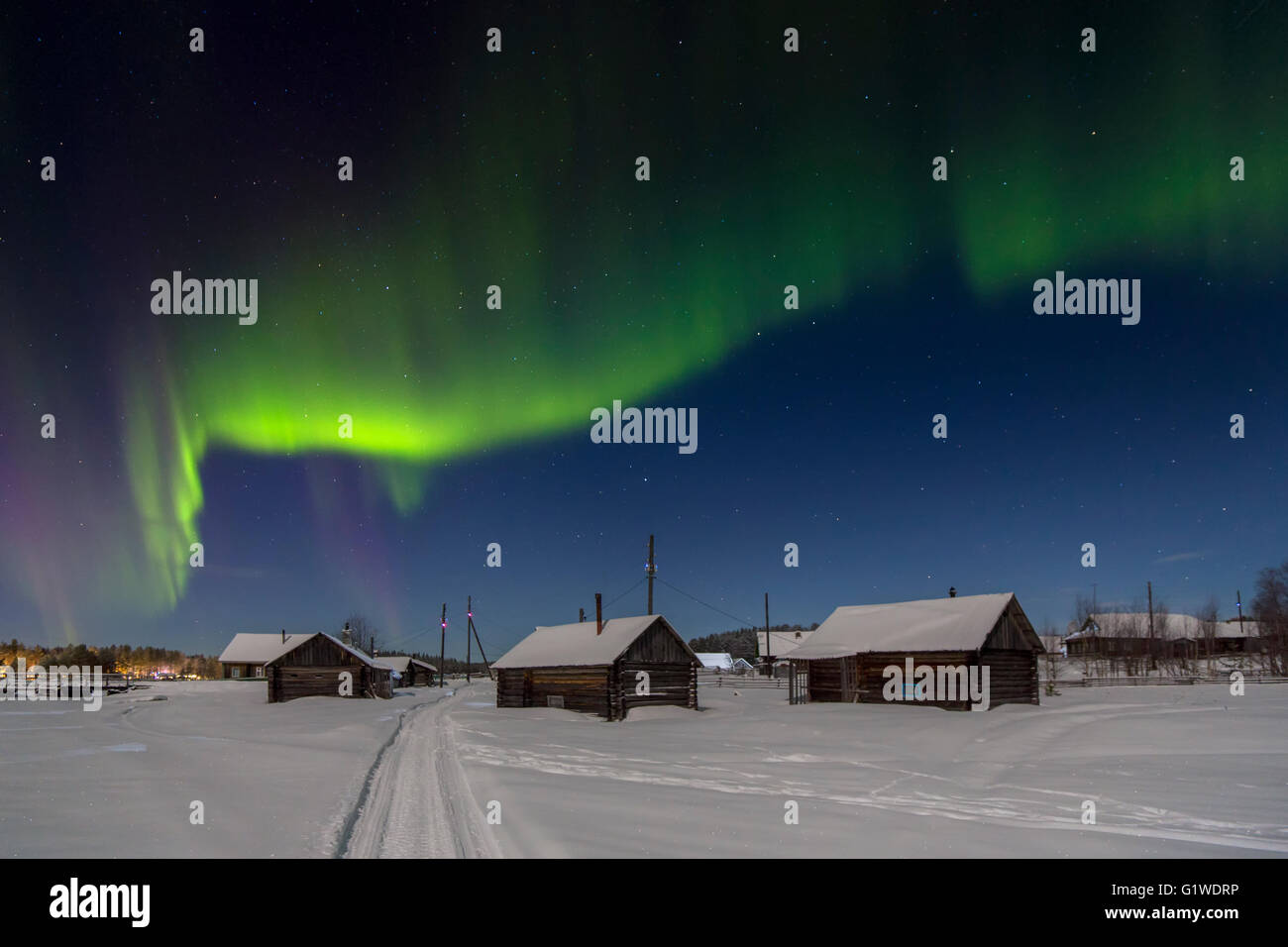 Village house in the lights of moon and Aurora borealis. Northern Karelia. Russia. Stock Photo