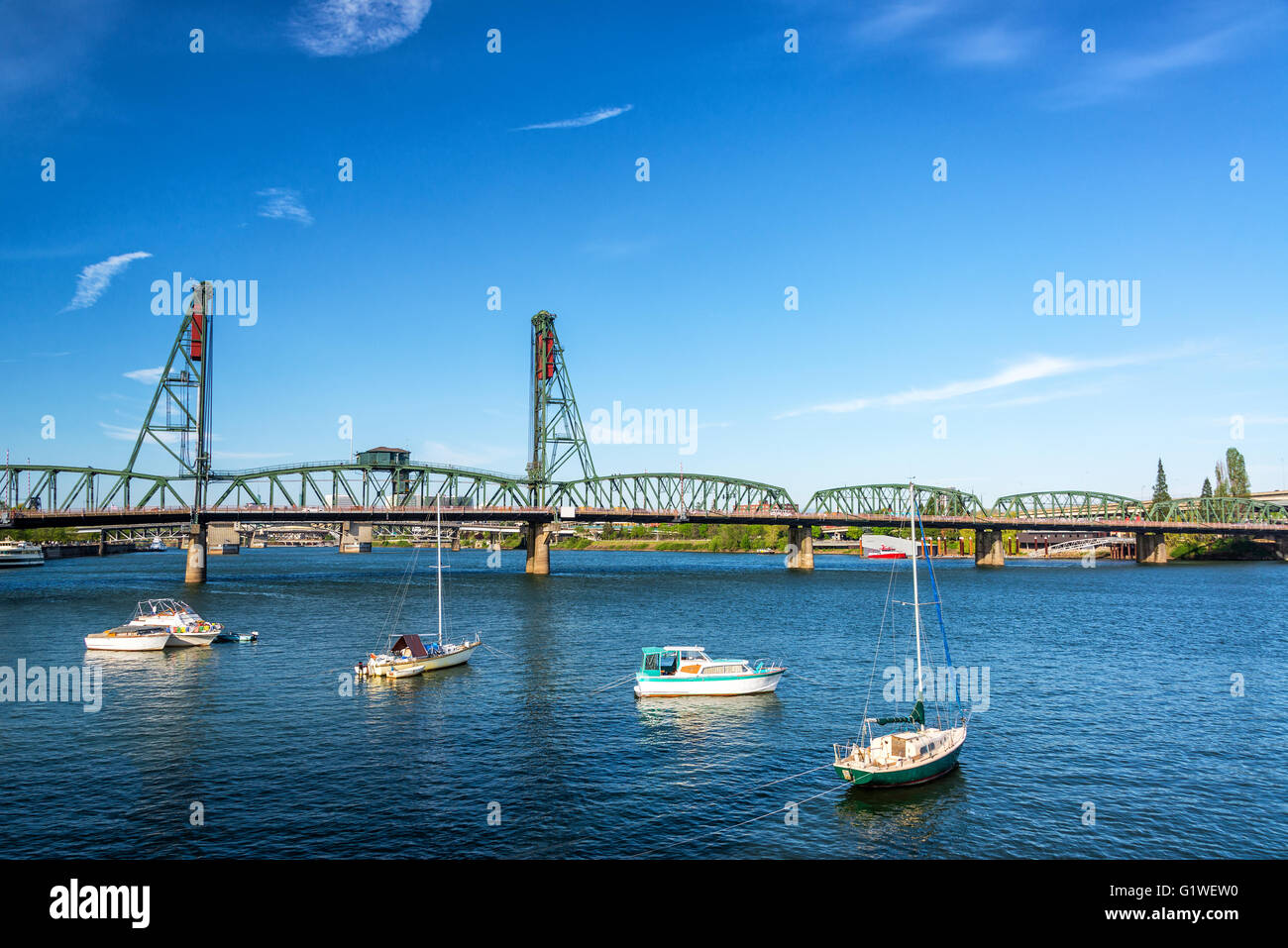 Four boats in front of the Hawthorne Bridge in Portland, Oregon Stock