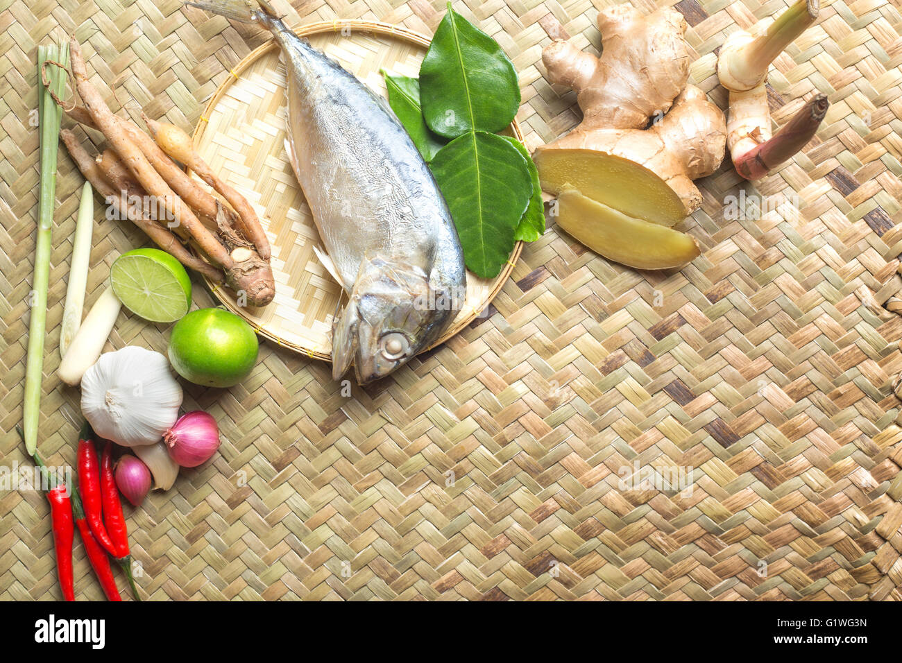 Thai food Ingredient of Tom Yum spicy soup With steamed mackerel Fish on wooden texture Stock Photo