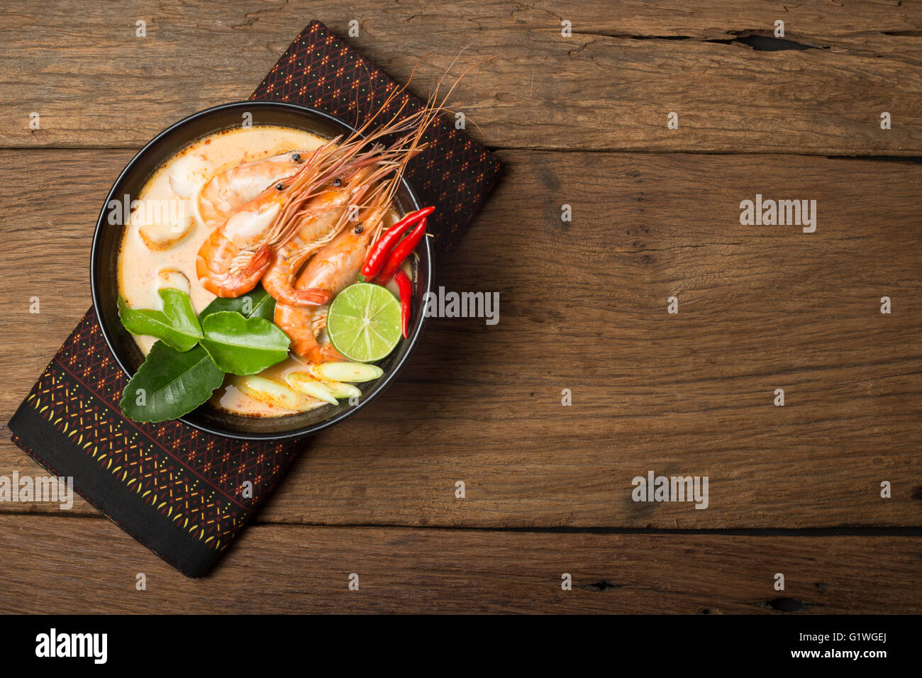 Tom Yum Goong traditional thai food cuisine in Thailand on wooden background Stock Photo