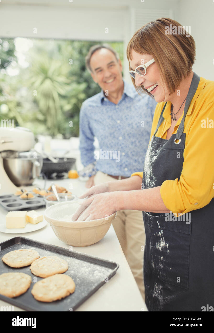 Mature couple baking cookies in kitchen Stock Photo