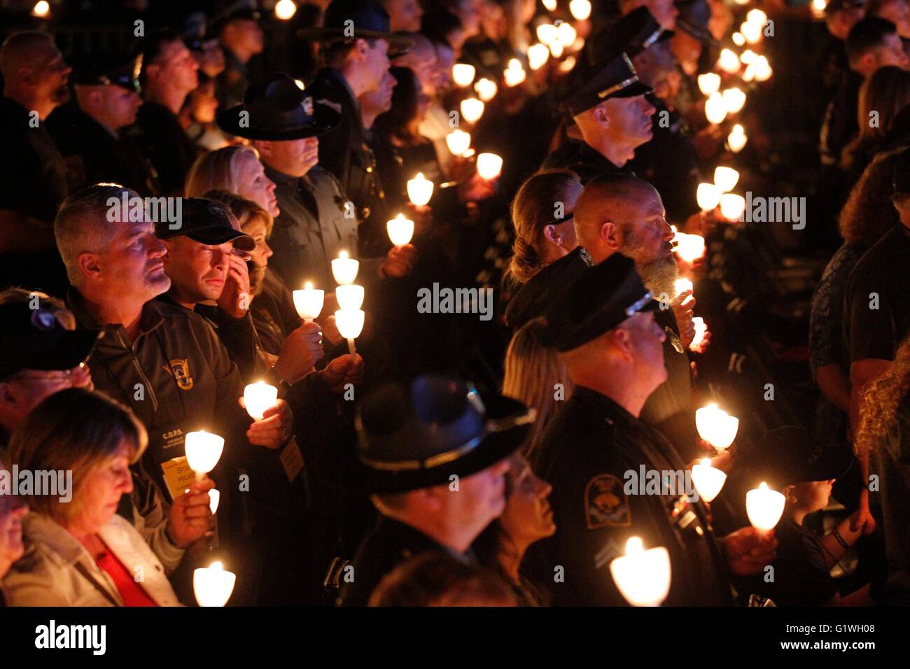 Hundreds of law enforcement officers and family members hold candles during a candlelight vigil held in memory of fallen officers on the National Mall May 13, 2016 in Washington, DC. Stock Photo