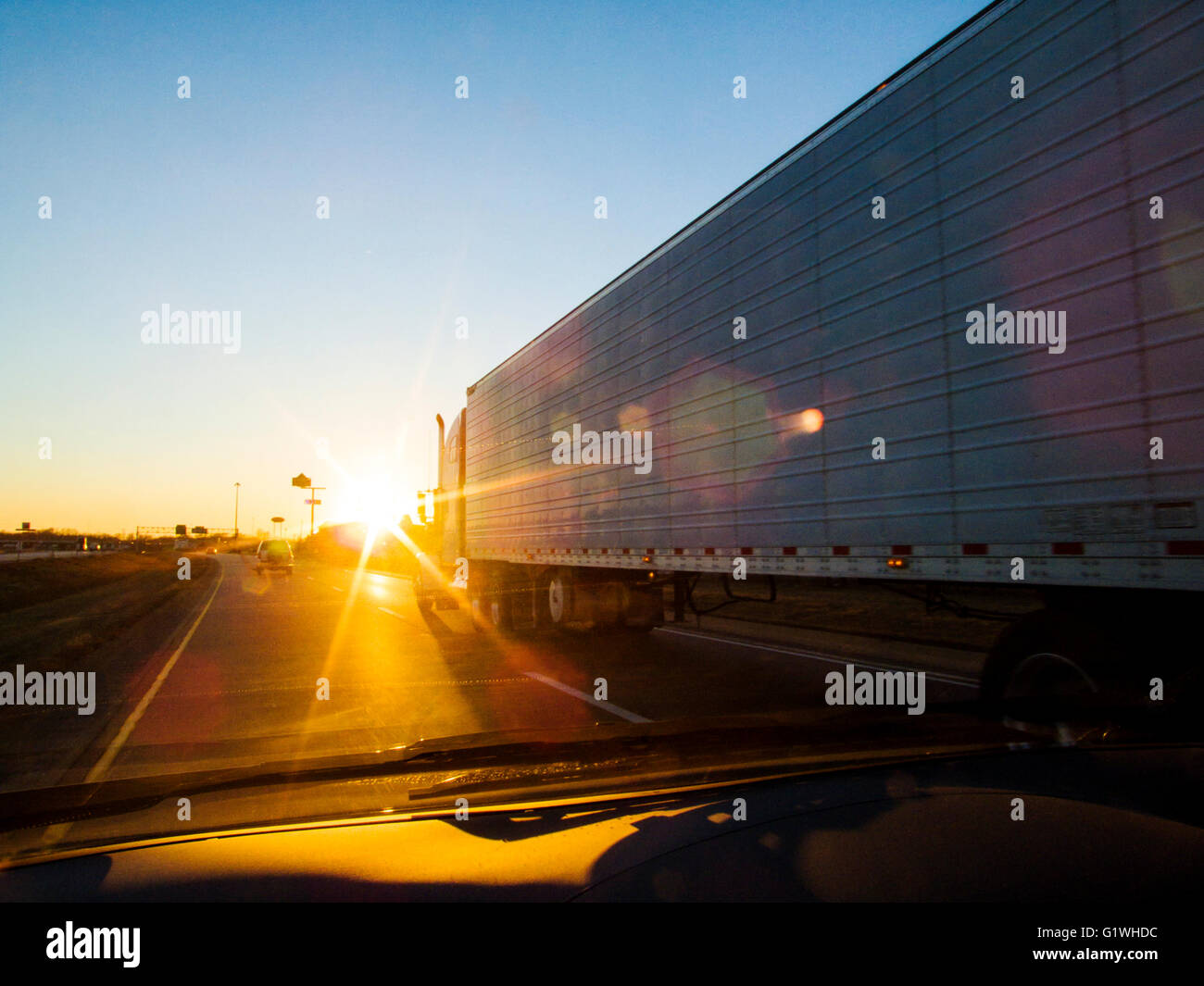 Sunset driver's view of tractor trailer on USA interstate highway 70