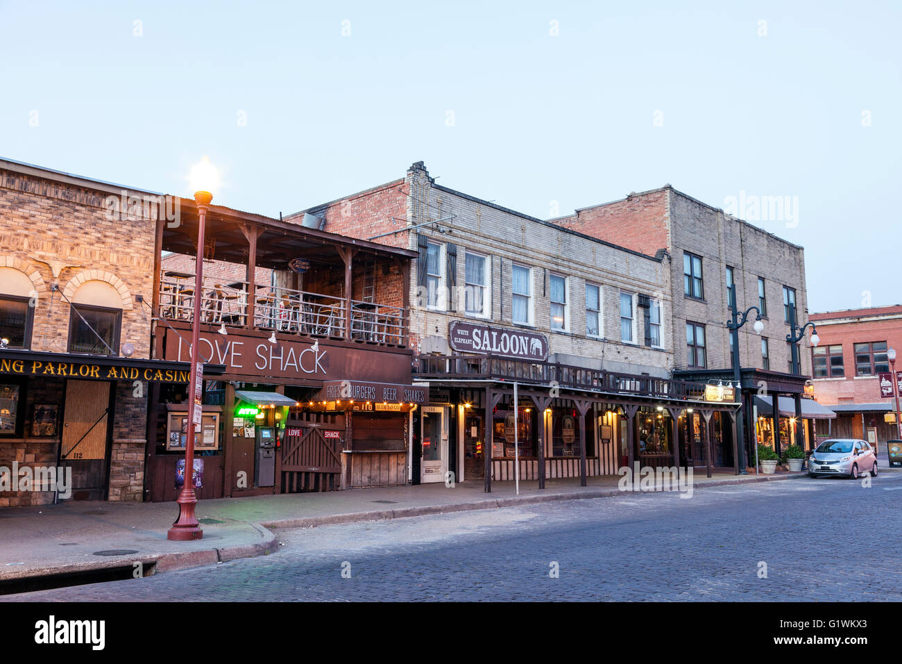 Street in the Fort Worth Stockyards district illuminated at dusk.Texas, USA Stock Photo