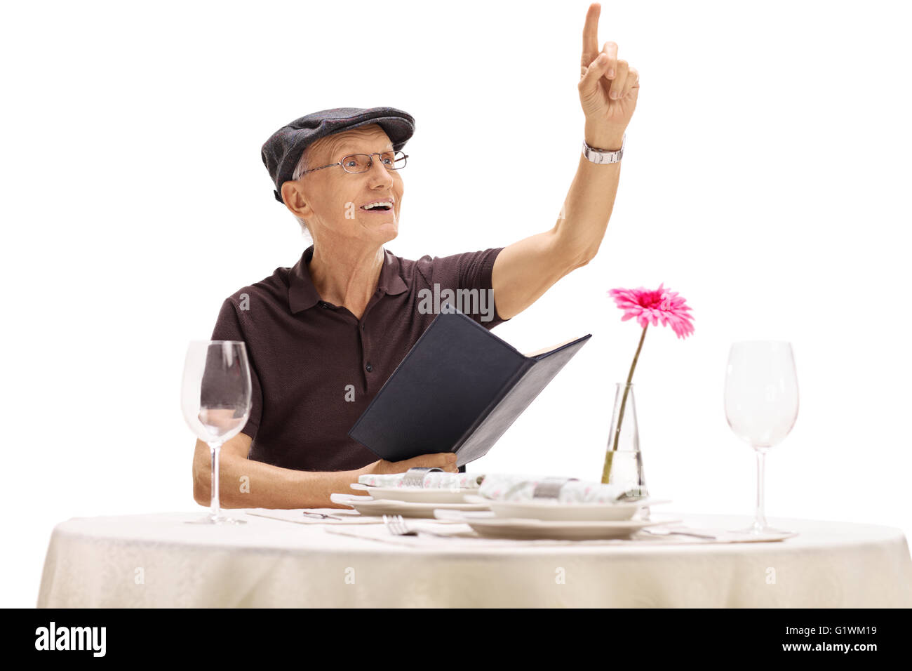 Senior gentleman holding a menu and calling a waiter in a restaurant isolated on white background Stock Photo