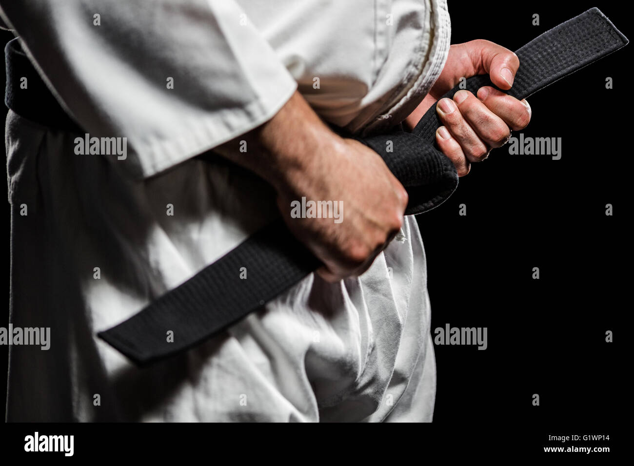 Fighter tightening karate belt Stock Photo Alamy
