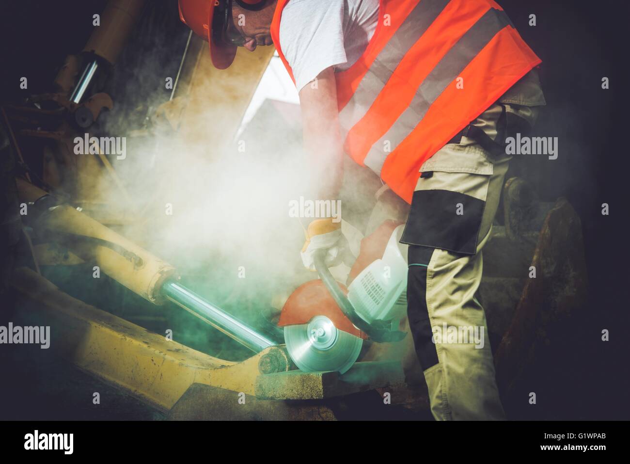 Construction Men Job. Caucasian Men with Stone Cutter at Work Stock