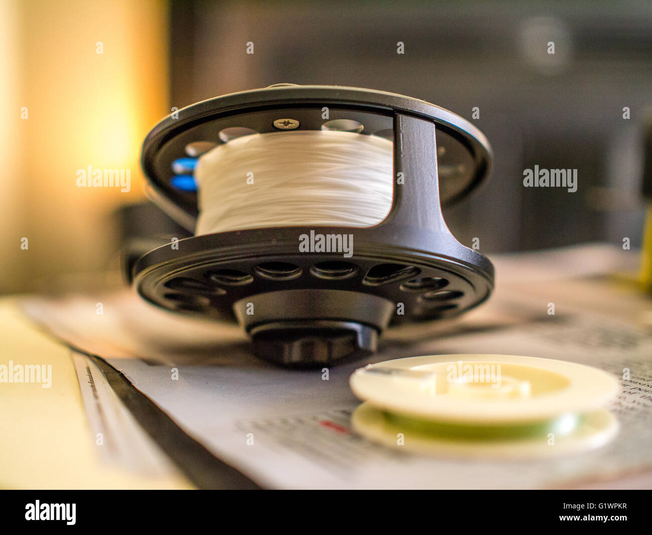 Fly fishing reel macro with white line Stock Photo