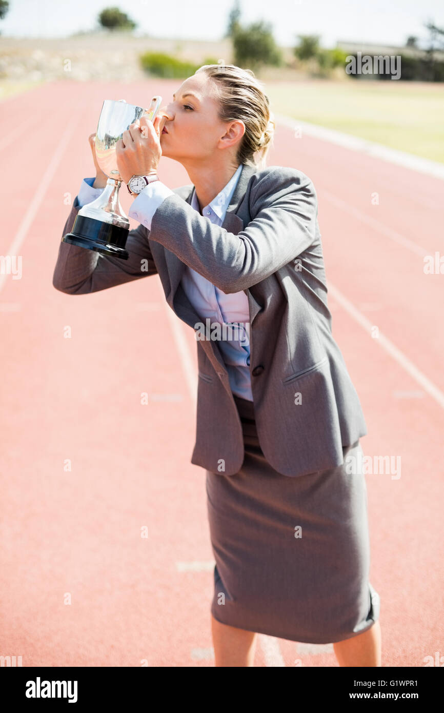 Happy businesswoman kissing her trophy Stock Photo