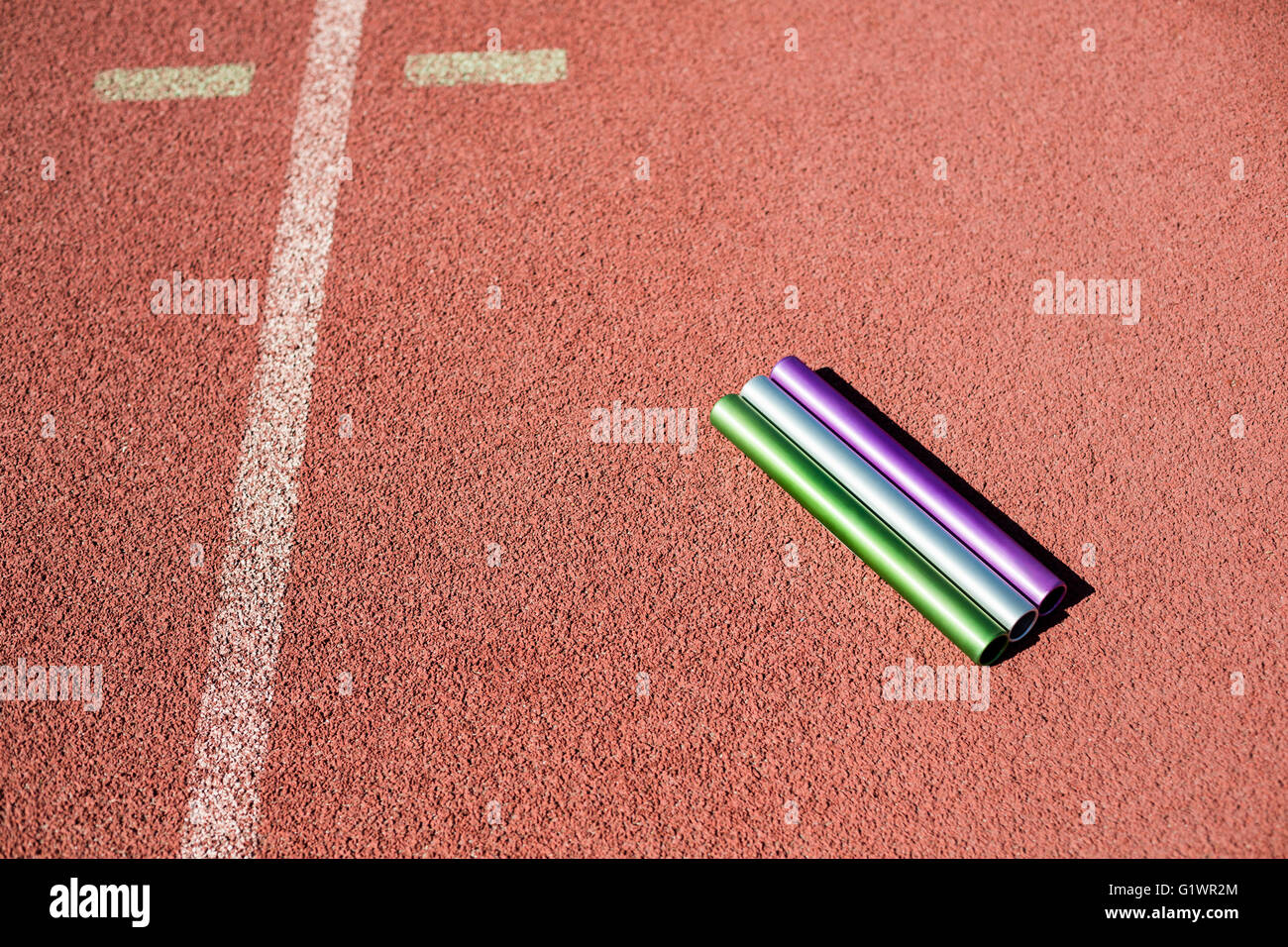 Relay baton on running track Stock Photo Alamy