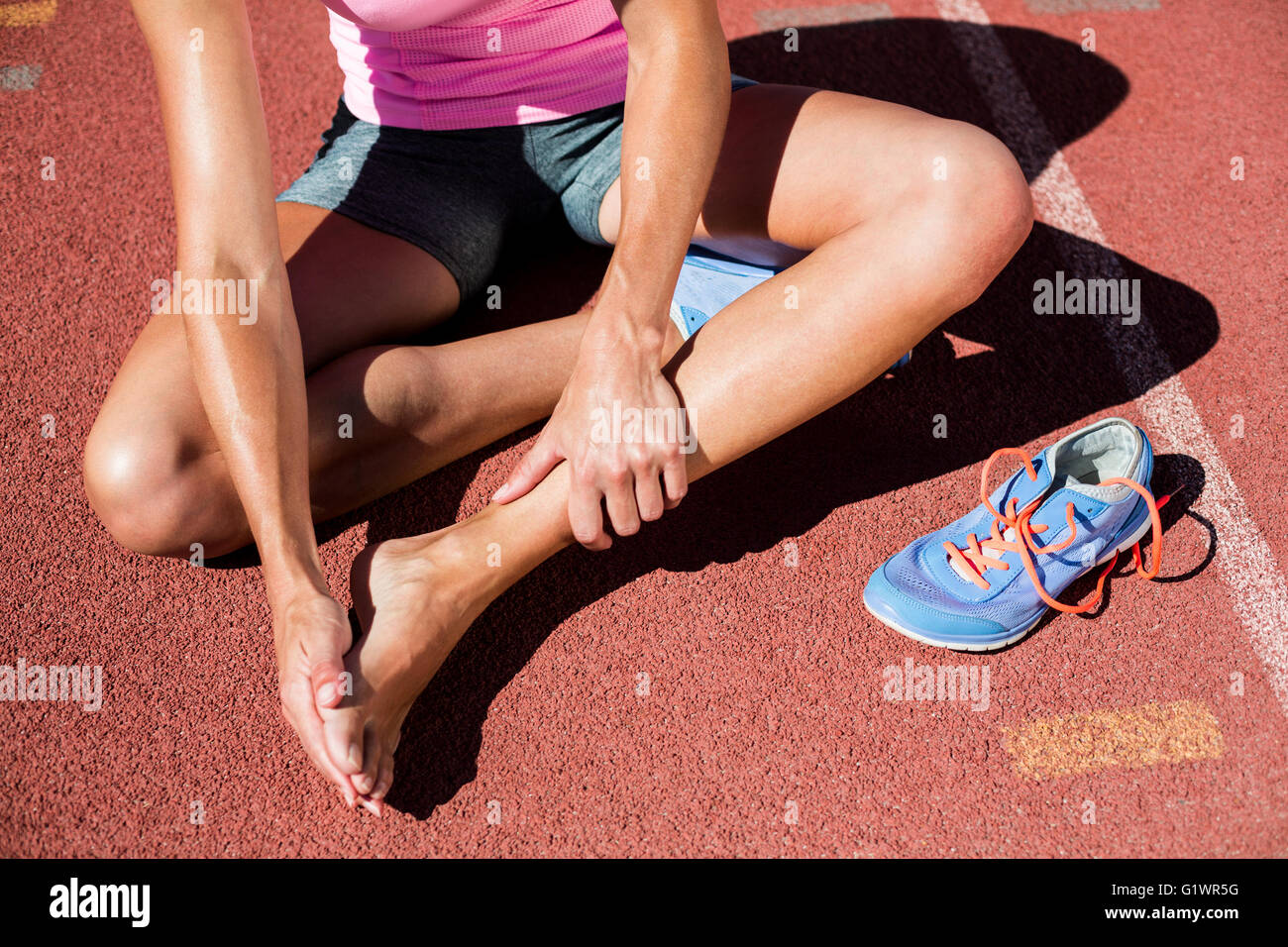 Female athlete with foot pain on running track Stock Photo Alamy